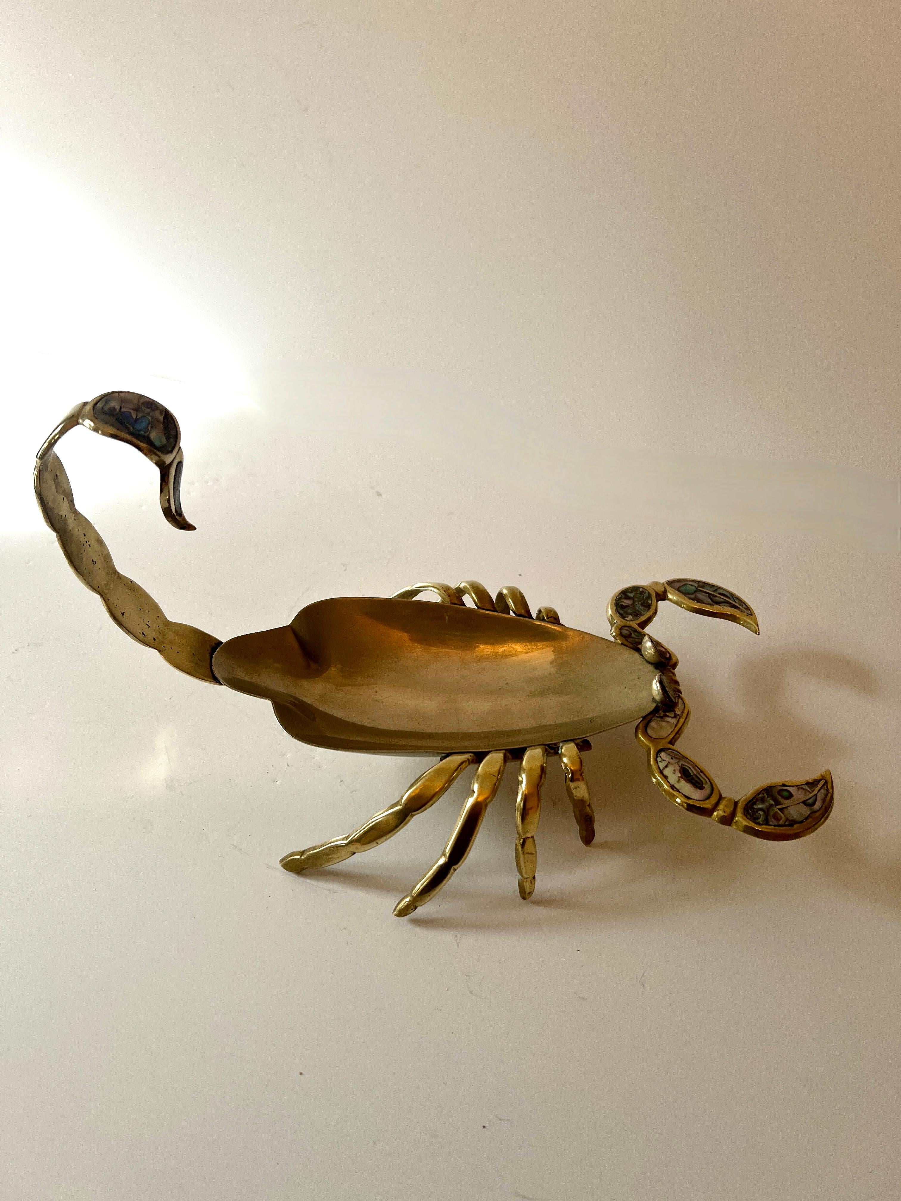 A wonderful Mexican  Metalwork in the style of Los Castillo.

The shape is that of a Scorpion with Brass legs, tail and pinchers, accented with abalone and a Chrome body... the piece is in great shape and polishes to a nice sheen.

A complement to