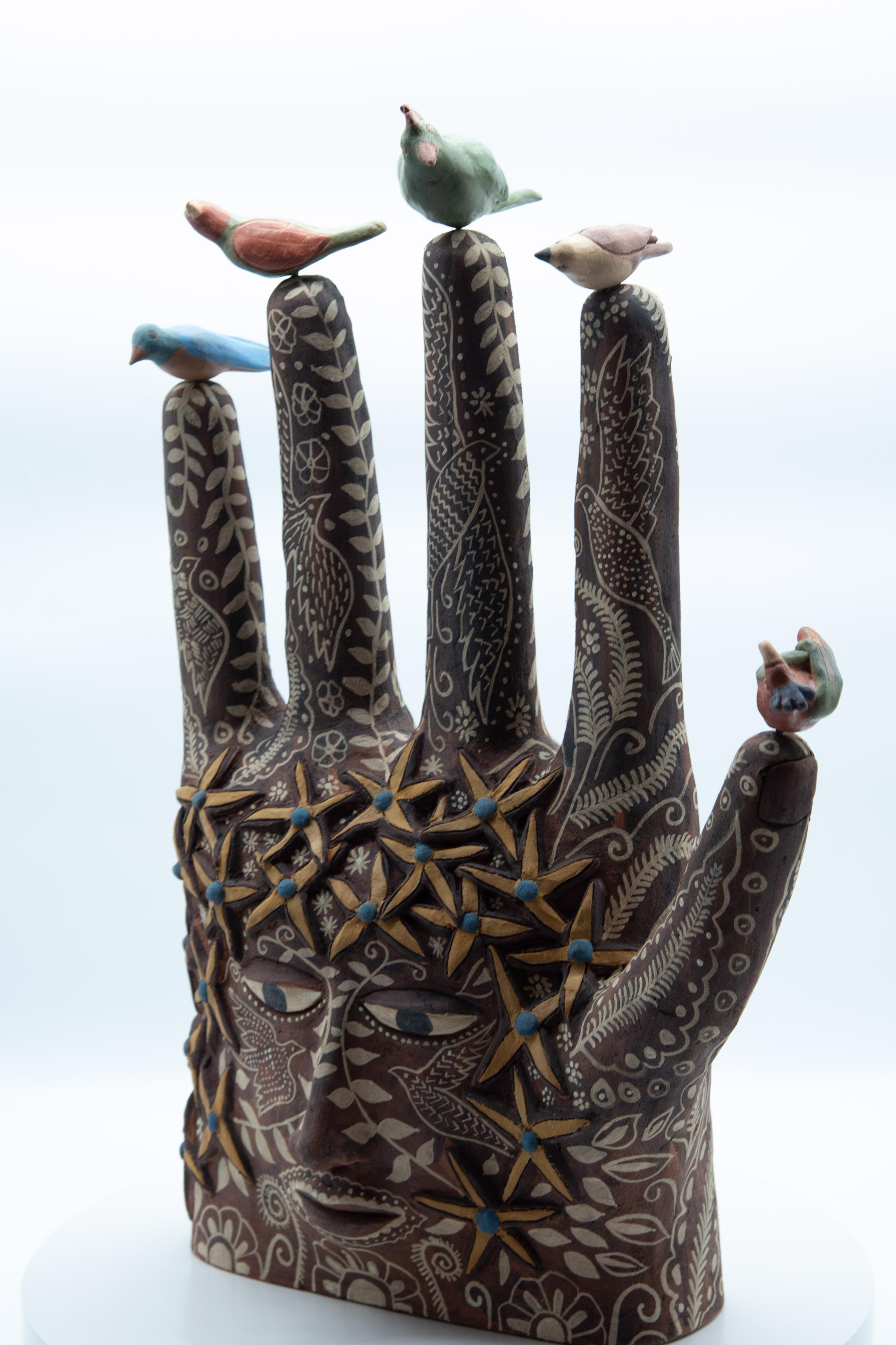 This Mexican ceramic clay hand sculpture is a piece by artist Manuel Reyes. Made with clay from Oaxaca and Zacatecas, painted with oxides from the region. Done with the hand-modeled technique and cooked in traditional wood-fired oven. The hand is