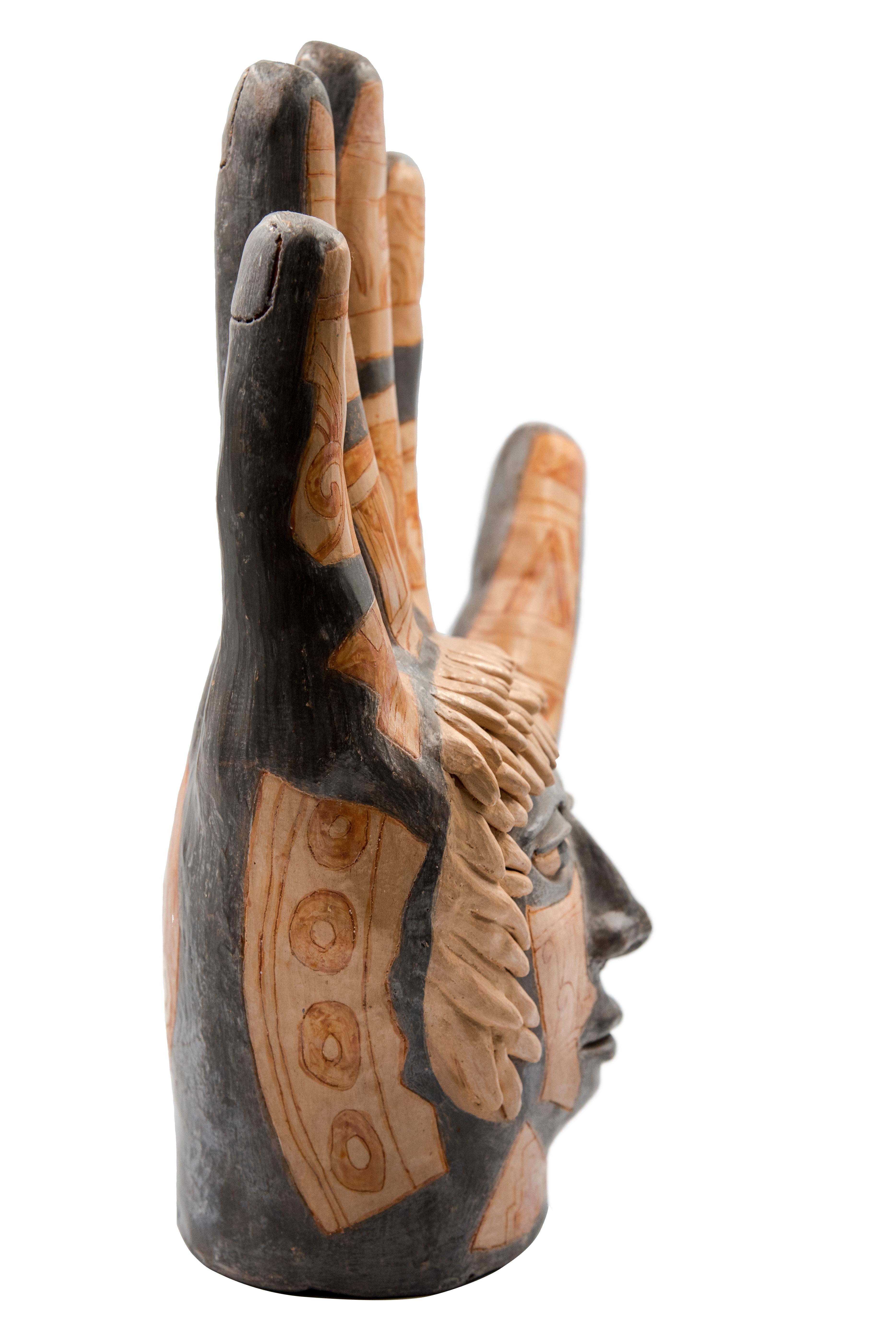 This Mexican ceramic clay hand sculpture is a piece by artist Manuel Reyes. Made with clay from Oaxaca and Zacatecas, painted with oxides from the region. Done with the hand-modeled technique and cooked in traditional wood-fired oven. The hand is