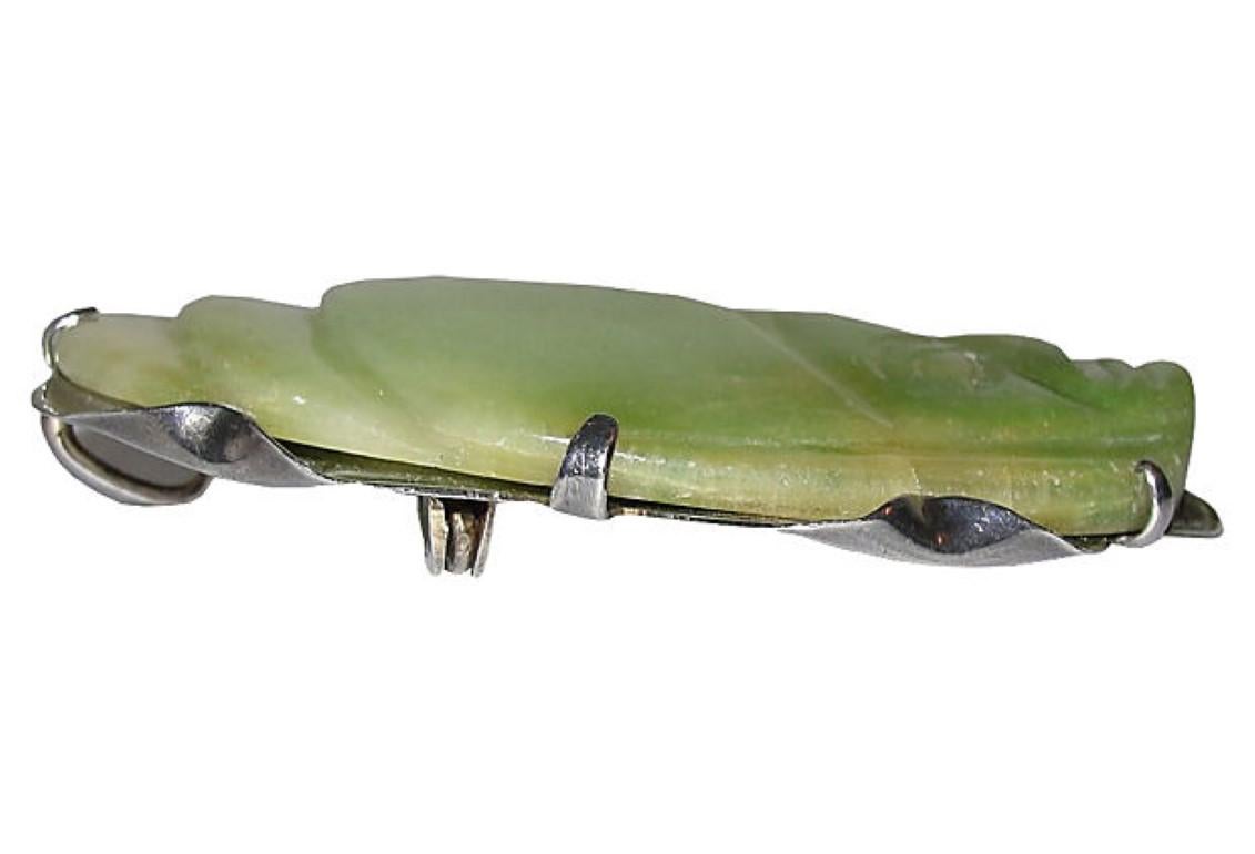 Handmade sterling silver brooch featuring a piece of jade hand-carved with face, circa 1950. Marked: Silver, Mexico. Can be worn as a pendant or brooch.
