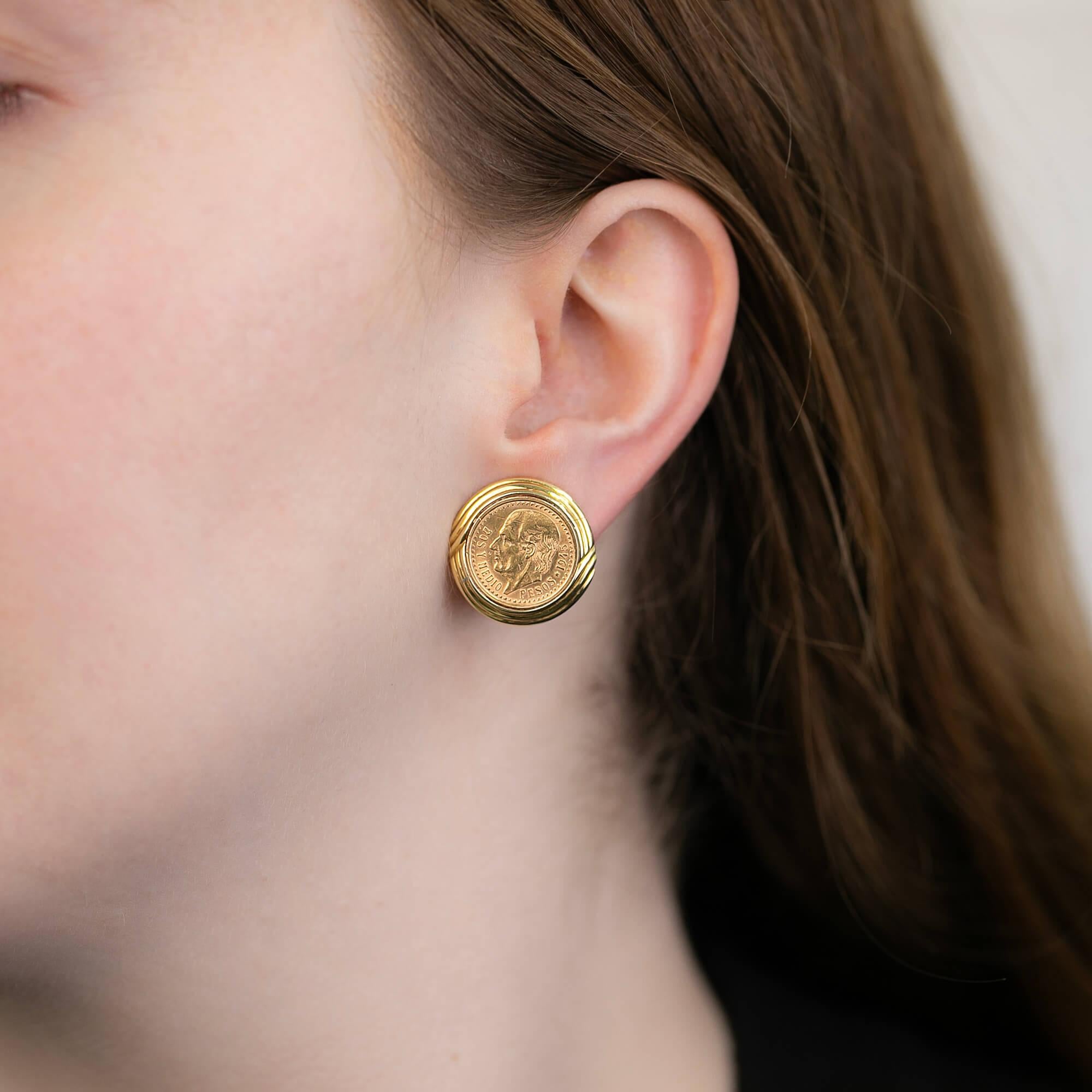 A pair of Mexican earrings, each featuring a 1945 Mexico 2.50 peso featuring Dos Y Medio. Held within a 18k yellow gold textured frame. These earrings are fitted with a post and French clip fitting for secure and easy wear.

Metal: 18k yellow gold