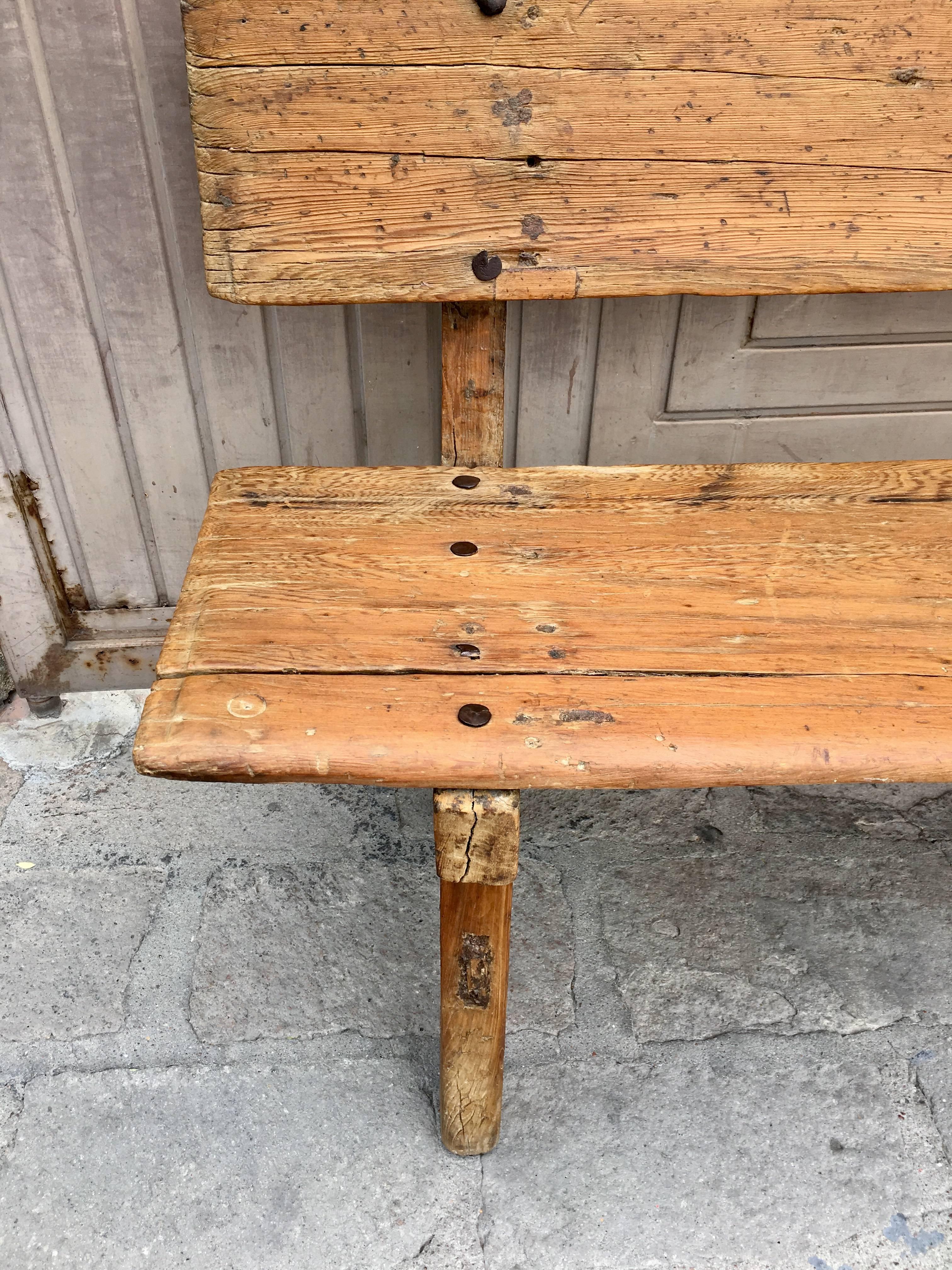 Colonial bench from Guanajuato, Mexico. Composed of local Bald Cypress wood using hand-forged iron nails. This rare bench is originally from an hacienda in the outskirts of San Miguel de Allende. The piece is structurally solid and all parts are