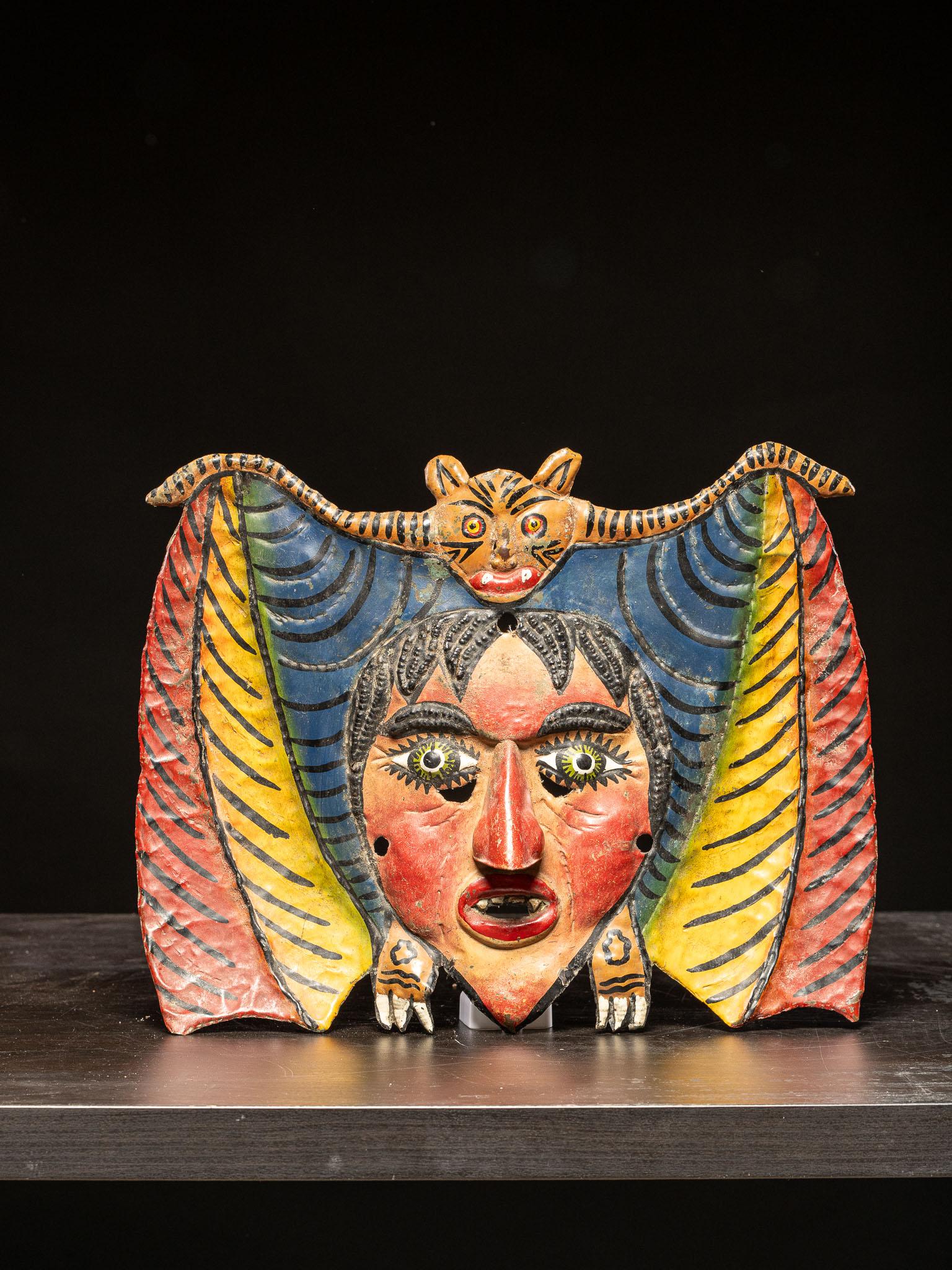 Rare and spectacular bat dance mask from Mexico. Crafted in the late 19th to early 20th century, with later retouches to the polychromy. This type of mask is made of hammered copper by members of the Nahua people and represents a remarkable example