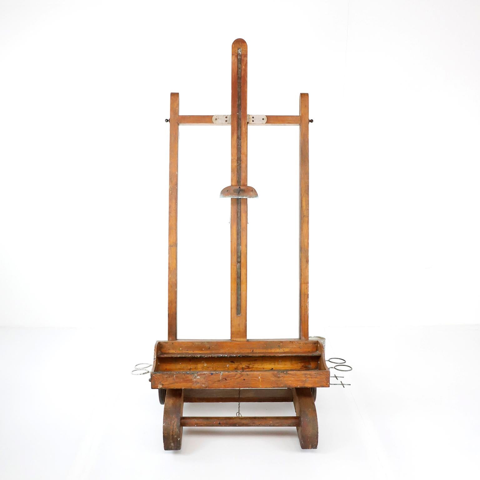 Rare Mexican wooden adjustable artist easel, circa 1940, made in pine wood has a nice old patina, with remnants of artistic creations of past, include some notes from the previous owner artist, height is adjustable.