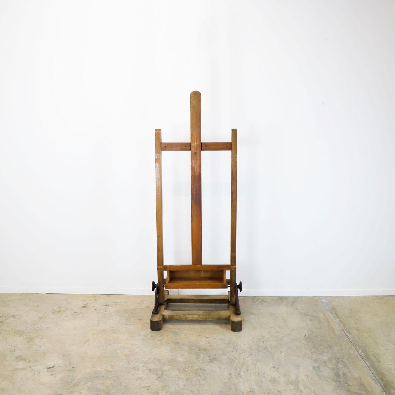 A Mexican wooden adjustable artist easel, circa 1950. This easel has the same design as those currently in the study of Diego Rivera and Frida Kahlo, has a nice old patina, with remnants of artistic creations of past, standing tall, ready for the