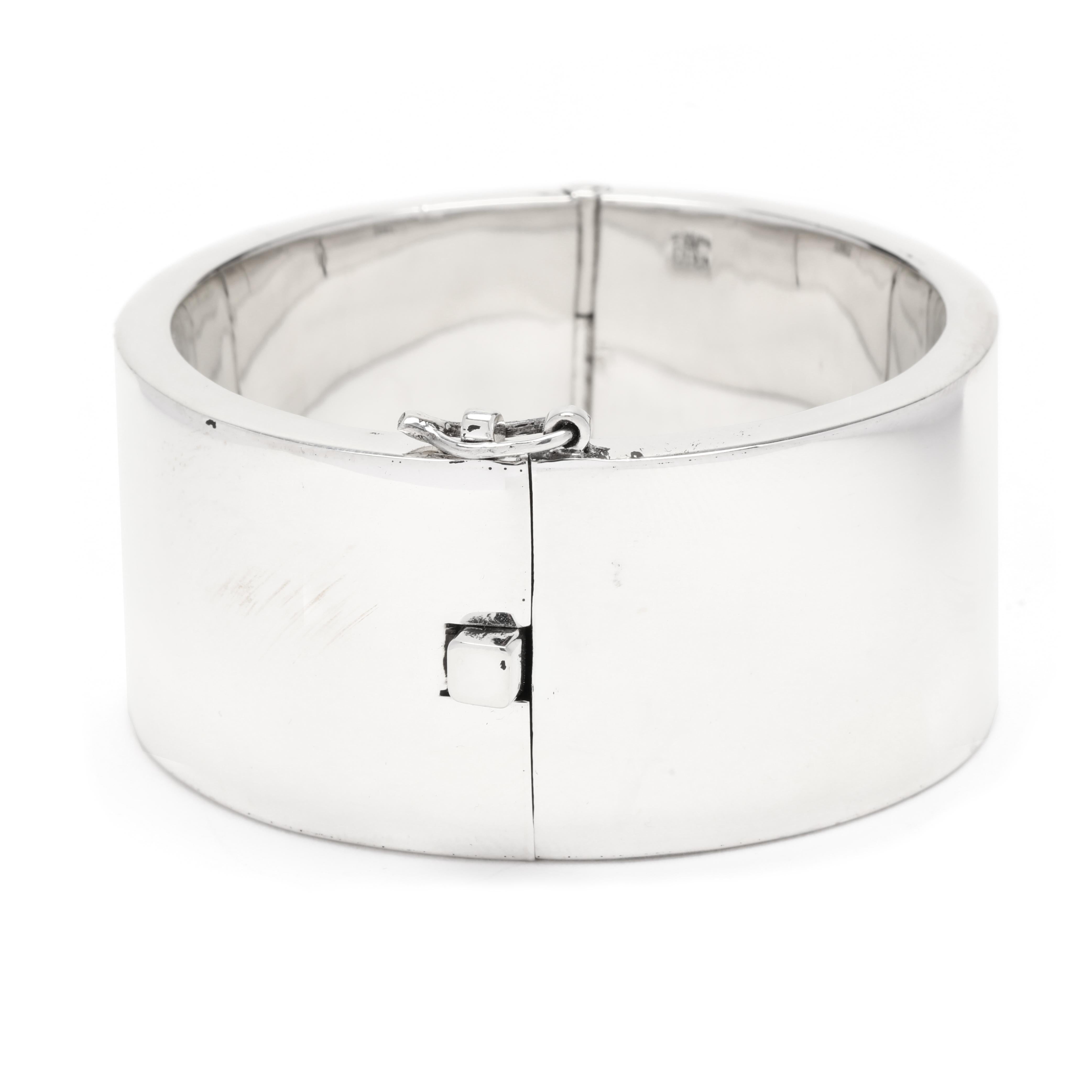 This elegant Mexican Escorcia extra wide bangle bracelet is the perfect statement piece for any jewelry enthusiast. Crafted from solid sterling silver, this 7-inch bracelet is sure to be a timeless addition to any collection. The intricate