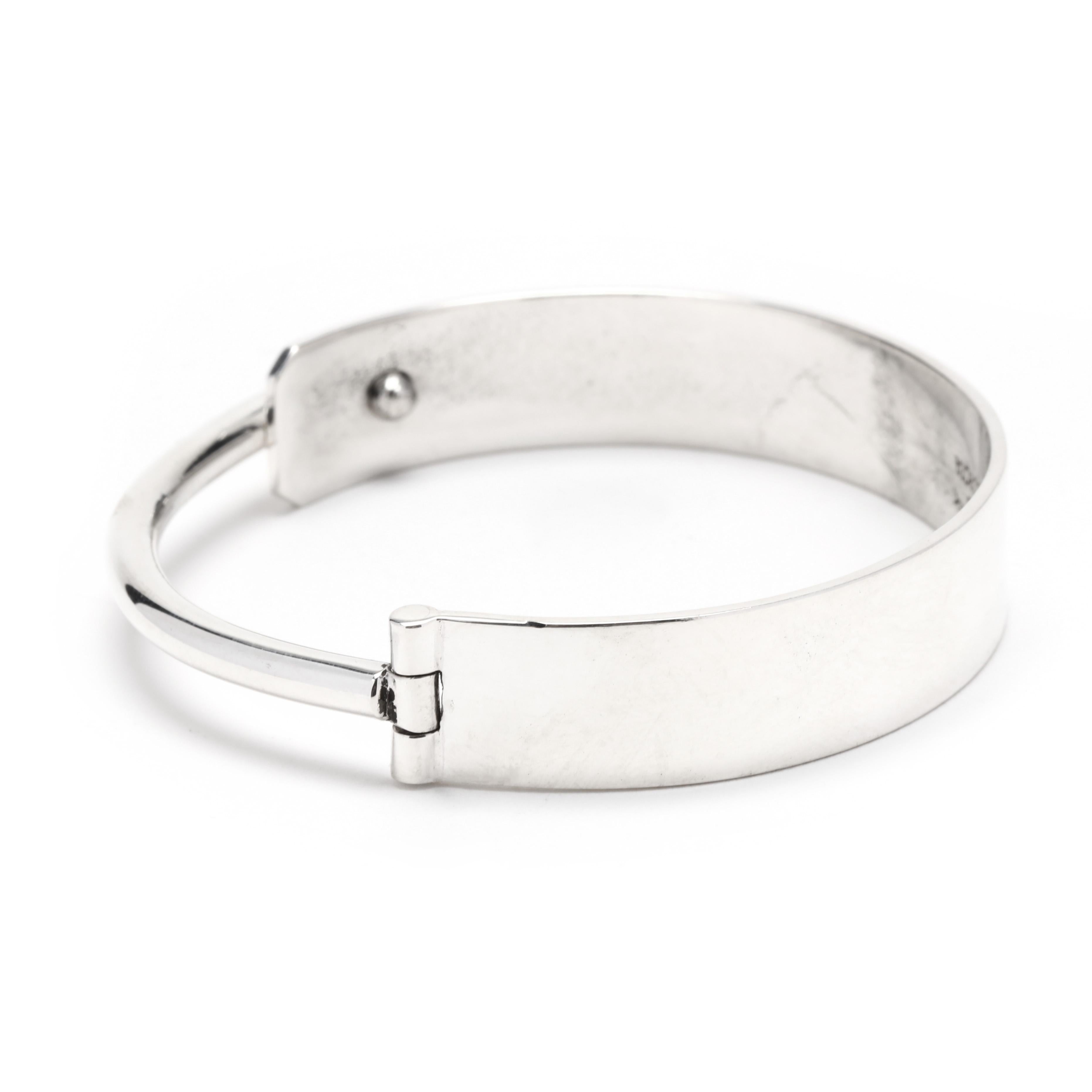 This elegant Mexican Escorcia Modern Hinged Bangle Bracelet is crafted from sterling silver for an eye-catching accessory. The simple design features a classic hinged bangle with an overall length of 7 inches. This timeless piece is perfect for