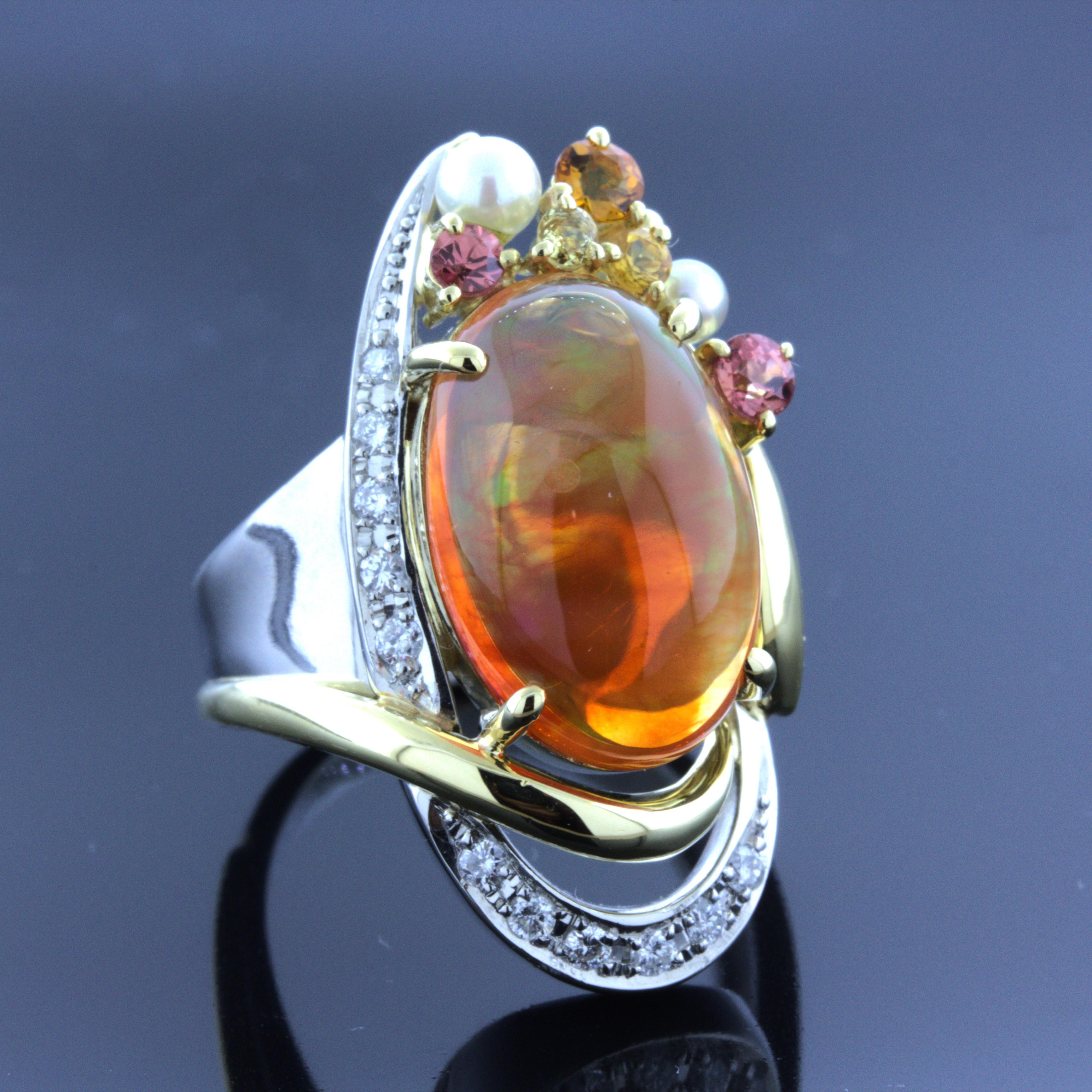 A stylish platinum ring that gives Autumn season vibes! It features a 5.86 carat fine Mexican fire opal with excellent play-of-color and a rich jelly orange color. It is complemented by 0.17 carats of round brilliant-cut diamonds, seed pearls, and
