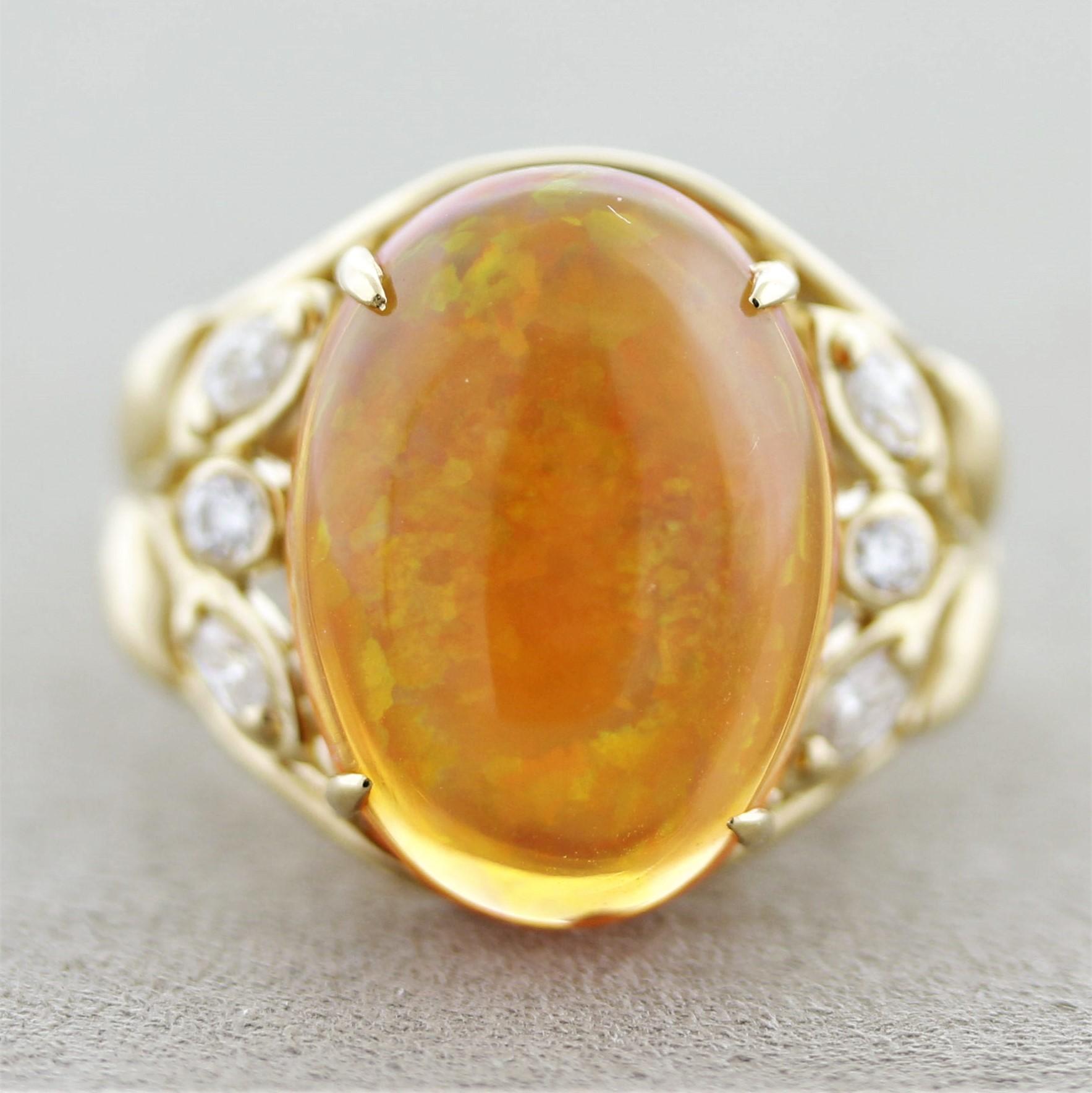 A lovely warm ring featuring a fine fire opal weighing 6.80 carats. It has a rich red-orange color along with excellent play-of-color as flashes of red, orange, yellow and green dance across the stone. It is complemented by 0.26 carats of round