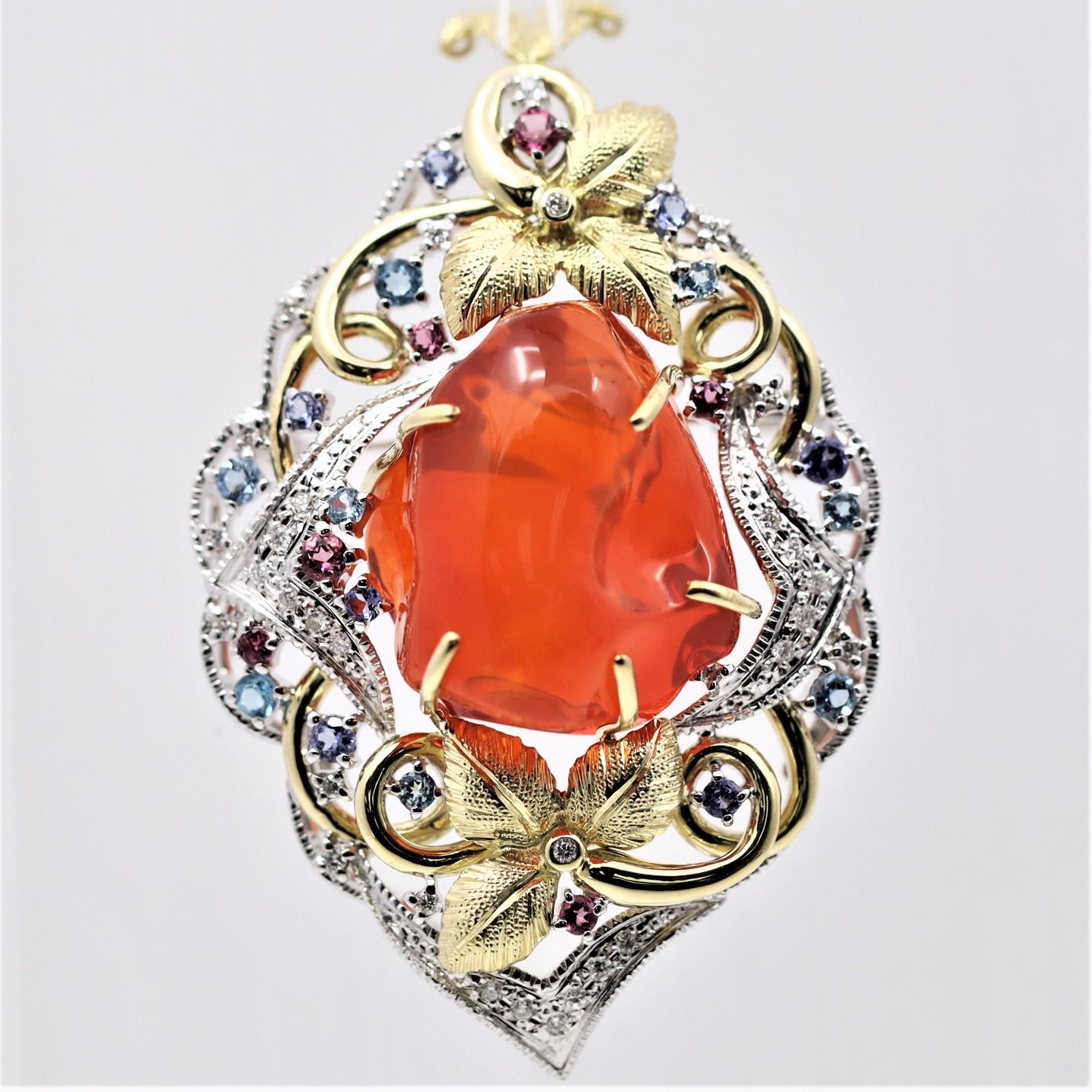 A unique, lively piece featuring a 36.89 carat fire opal with excellent quality! It has flashes of greens, oranges, and yellows dancing across its surface as the light hits it. IT is accented by 0.32 carats of round brilliant-cut diamonds, which add