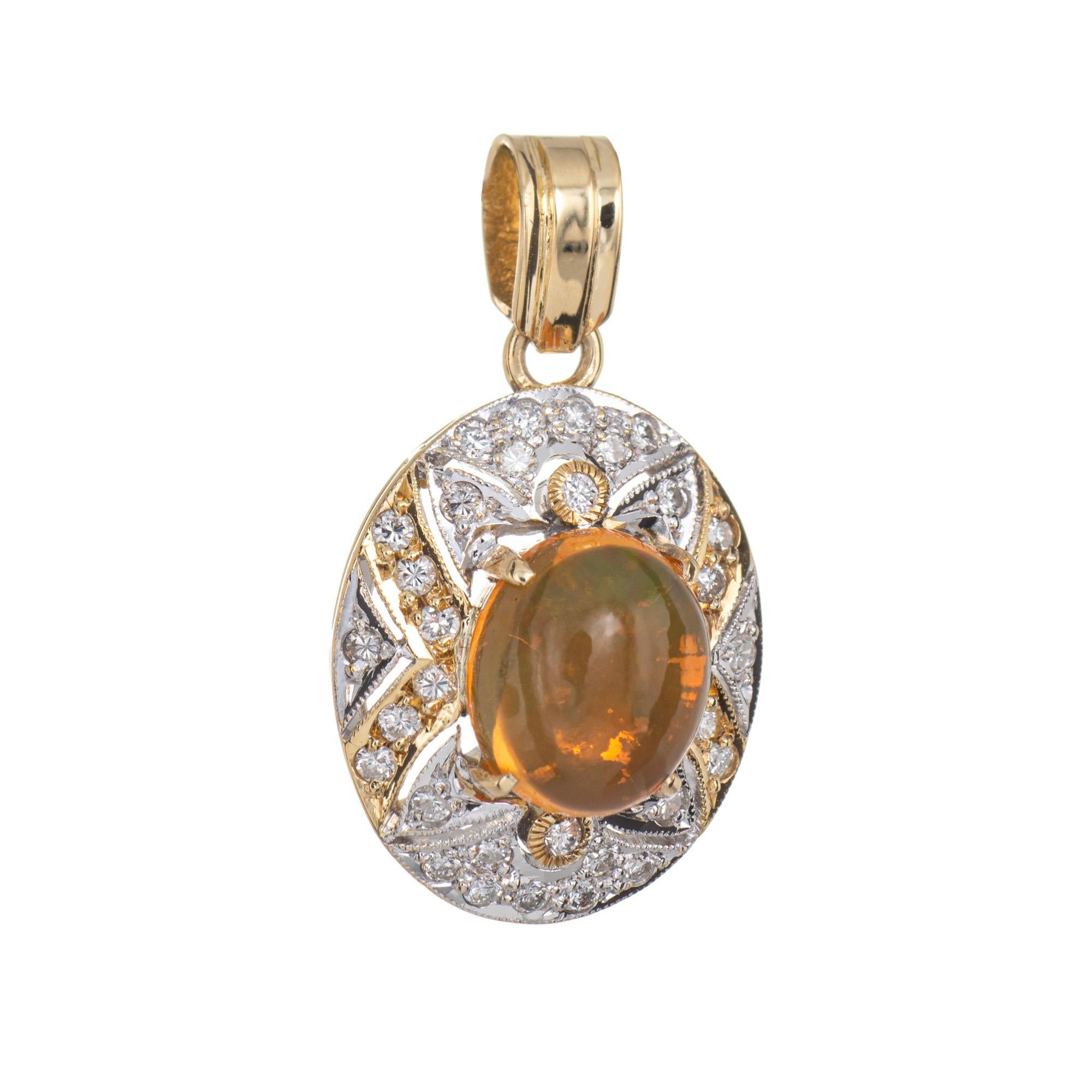 Finely detailed vintage opal & diamond pendant crafted in 14k yellow gold.  

The opal measures 10mm x 8mm (estimated at 3 carats), accented with an estimated 0.16 carats of diamonds (estimated at H-I color and SI1-2 clarity). The opal is in