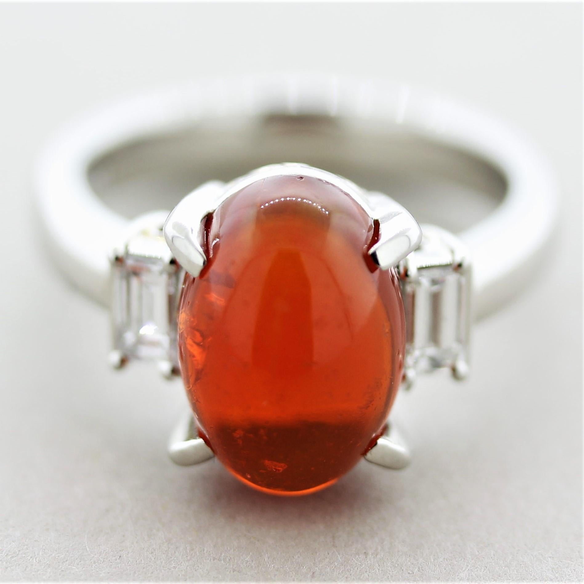 A classic 3-stone design, this lovely ring features a fine 3.65 carat fire opal with play-of-color. Fire opals are known for their intense deep red color but rarely show play of color. This example has a fine intense color as well as showing flashes