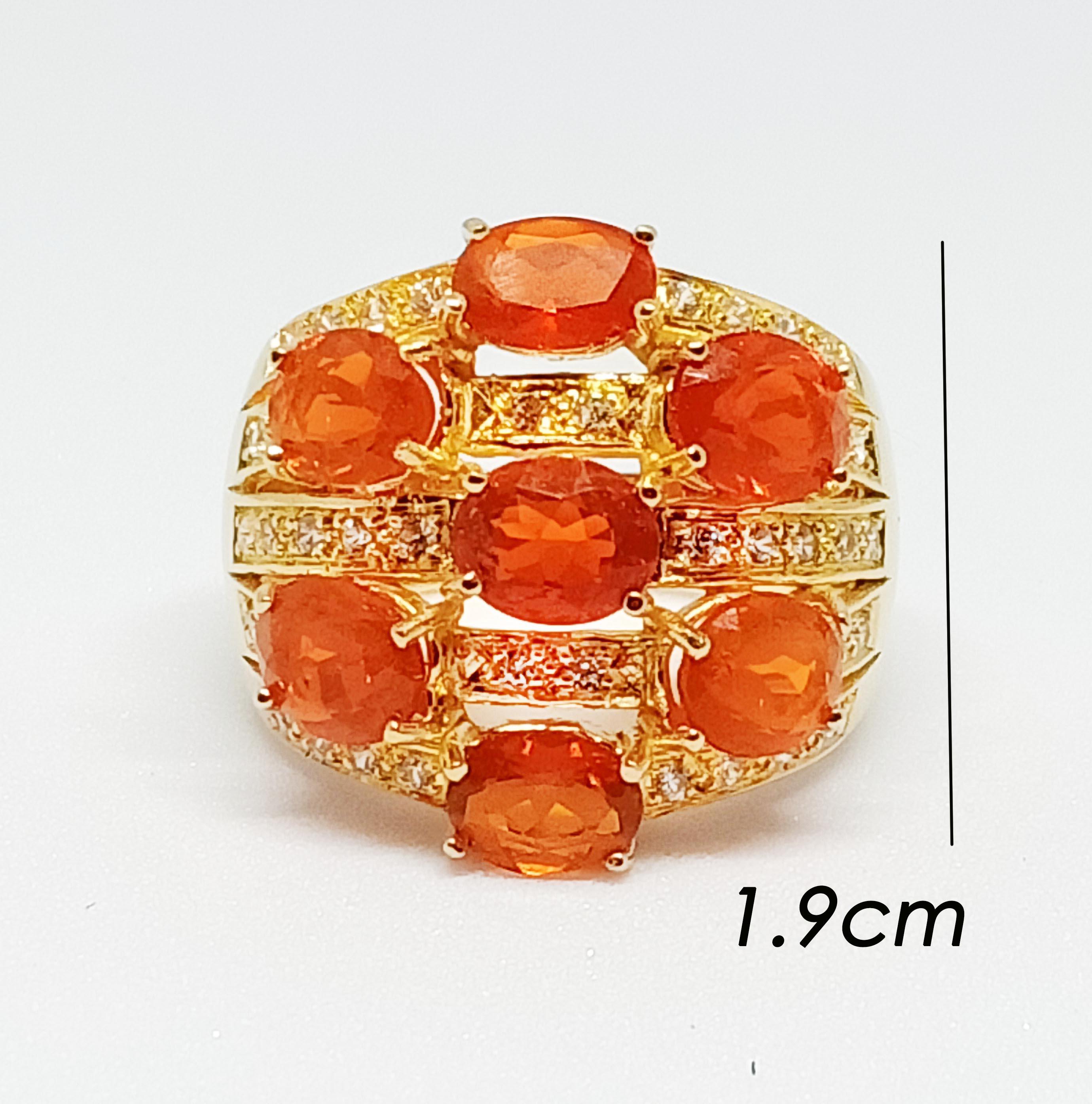 Mexican fire opal oval (3.38cts)  7 pcs.
white zircon round   1.25mm.  38 pcs.
18K gold plated over sterling silver
size 7.25 us.

Search ( stroefront , seller ) ornamento jewellery


