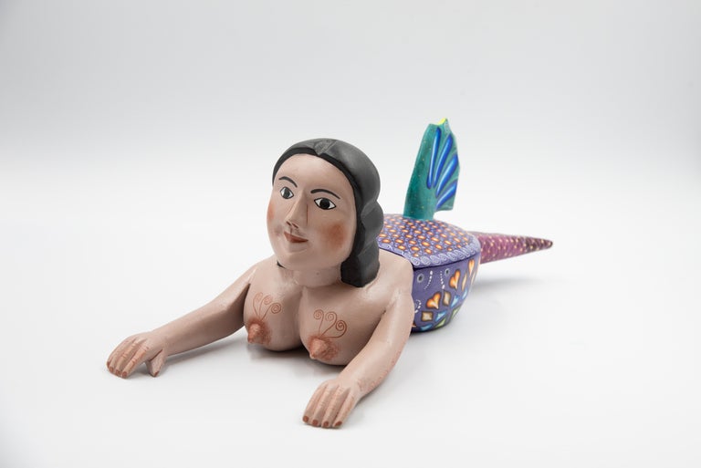 One of a kind wood carving mermaid piece by Agustin Cruz Prudencio. This delicate Alebrije is hand carved and painted with colorful acrylic colors. Inspired by local legends from Oaxaca, this piece is made into a jewel box in the form of a mermaid.