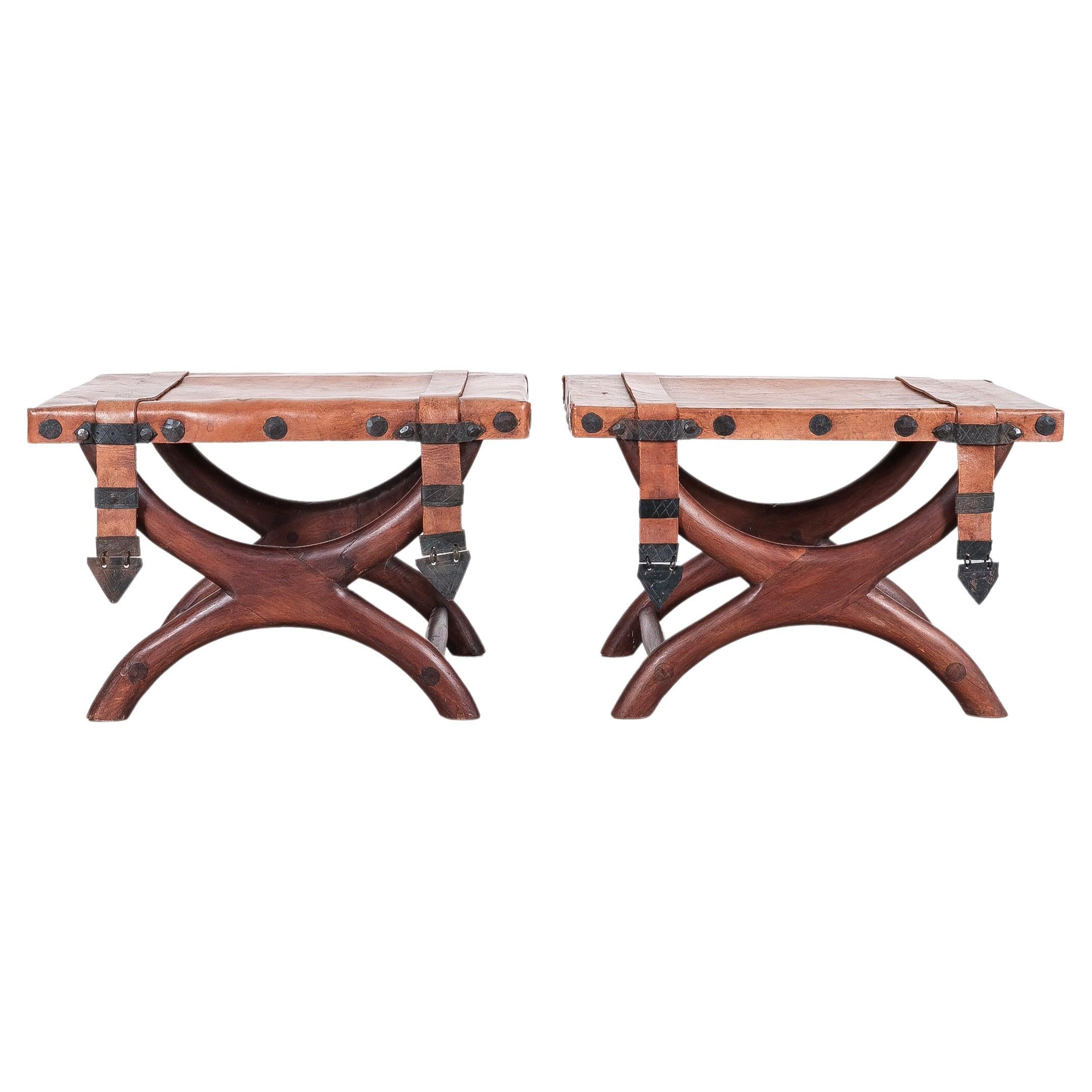 Pair of mid-century Mexican mahogany and leather stools, circa 1940-1950. 

Very hard to find in pairs. 

Nice pair of wooden vintage Spanish Colonial Curule stools with original thick leather covers and wrought iron knobs in good condition. It has