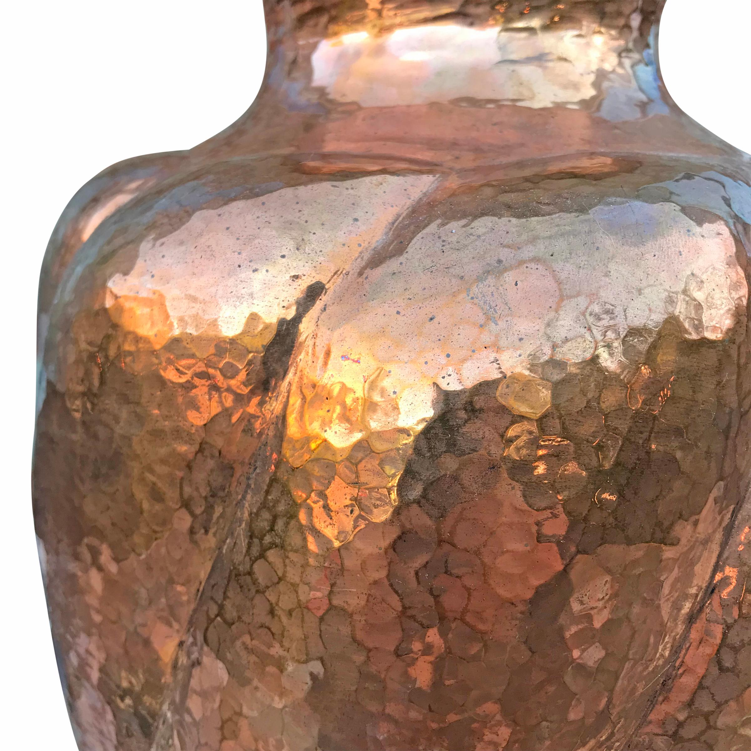 A beautiful Mexican hand-hammered copper vase with a swirled pattern, and a wonderful patina. The thickness of the copper on this vase makes it a wonderfully heavy and beautiful object.