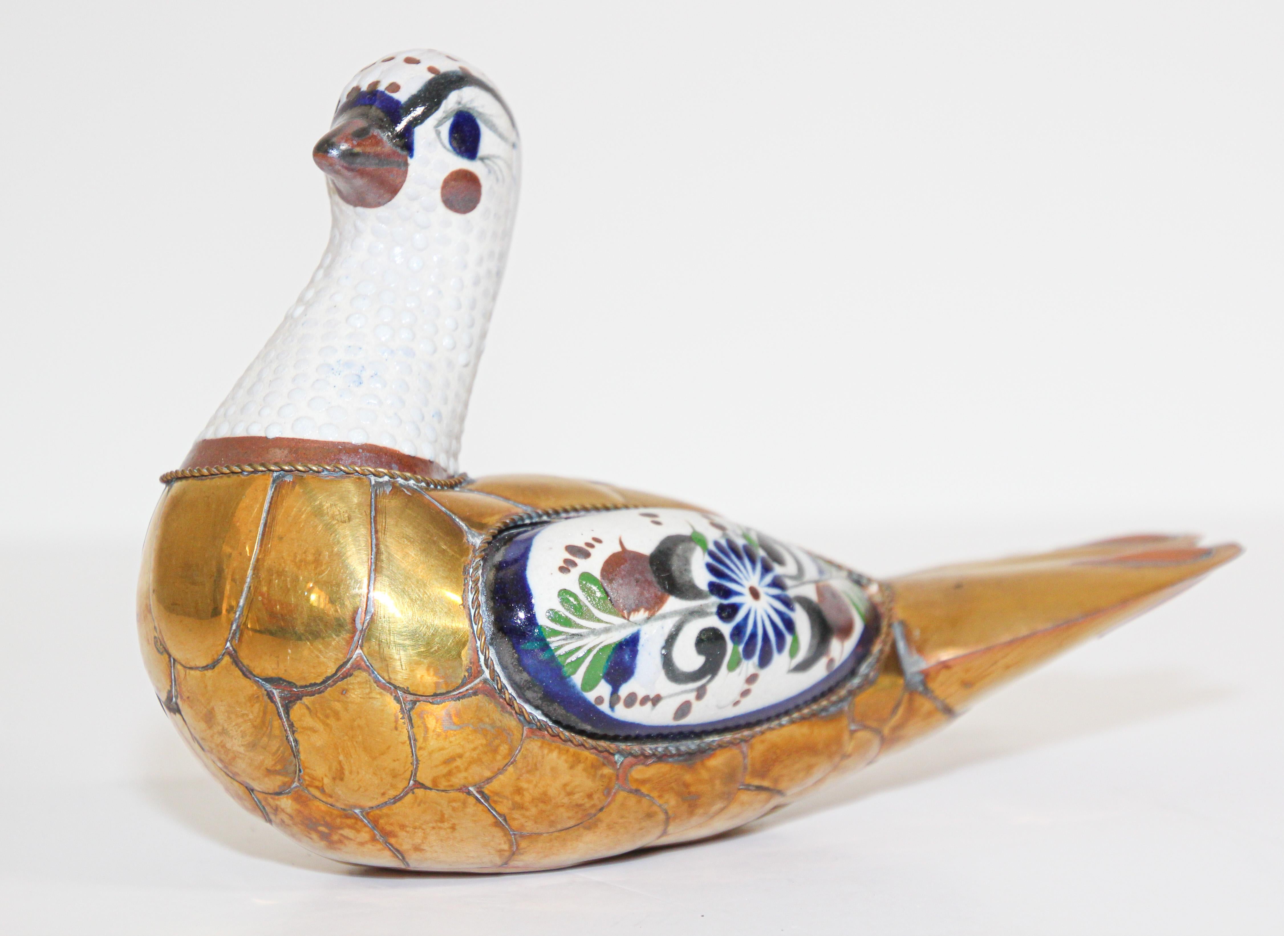 Vintage Mexican Tonala hand painted pottery bird Folk Art with brass decoration in the style of Sergio Bustamante.
Flora de la Cruz Acapulco Gro Mexico hand painted bird dove ceramic.
A beautiful piece of Tonala pottery encased in brass, Artistry