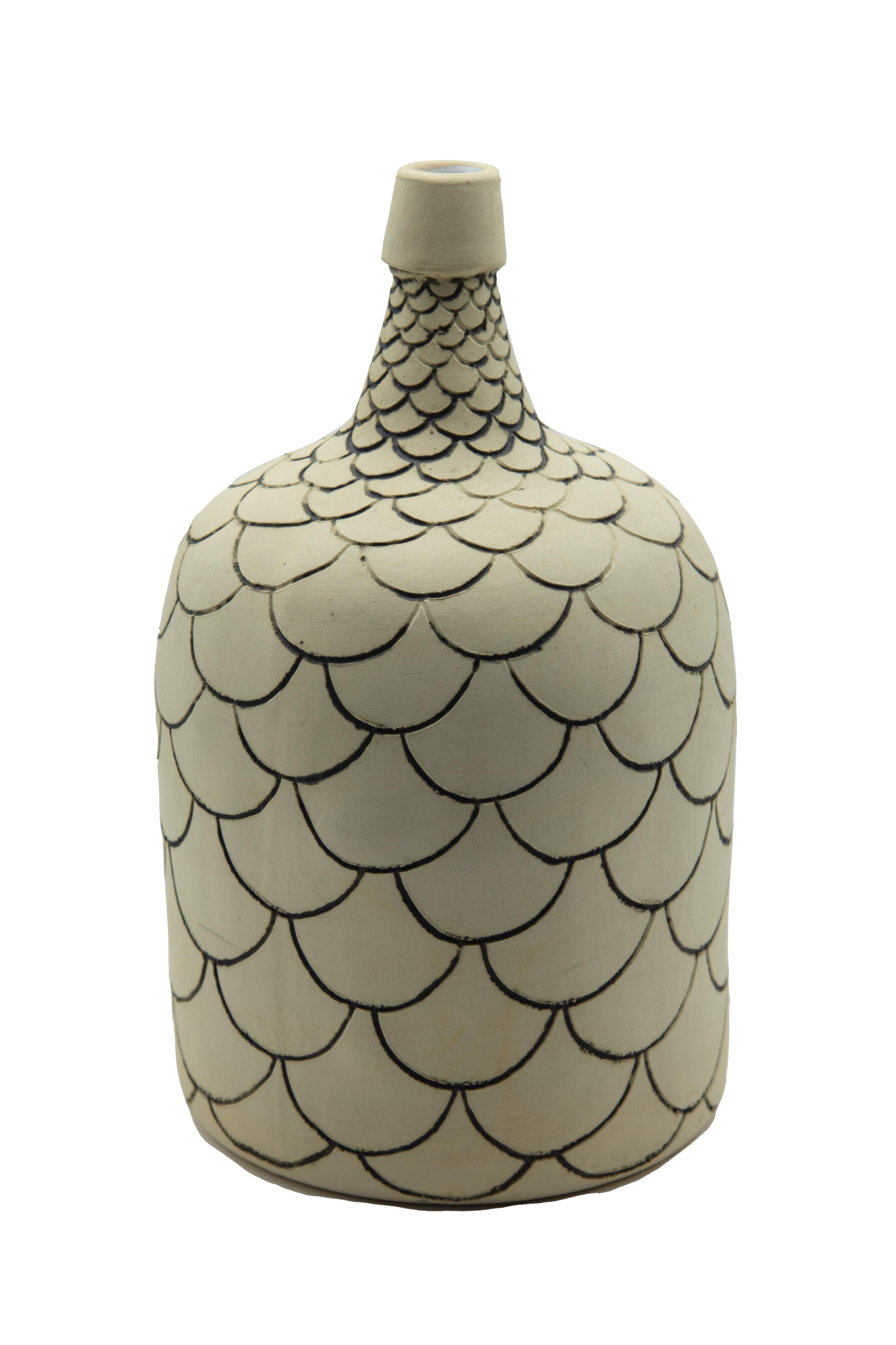 This rustic mezcal bottle is a replica of an antique bottle or demijohn which was used to store mezcal, drunken during folk theaters in Oaxaca, Mexico. The bottle is done with ceramic graffiti sgraffito technique which is later painted with oxide