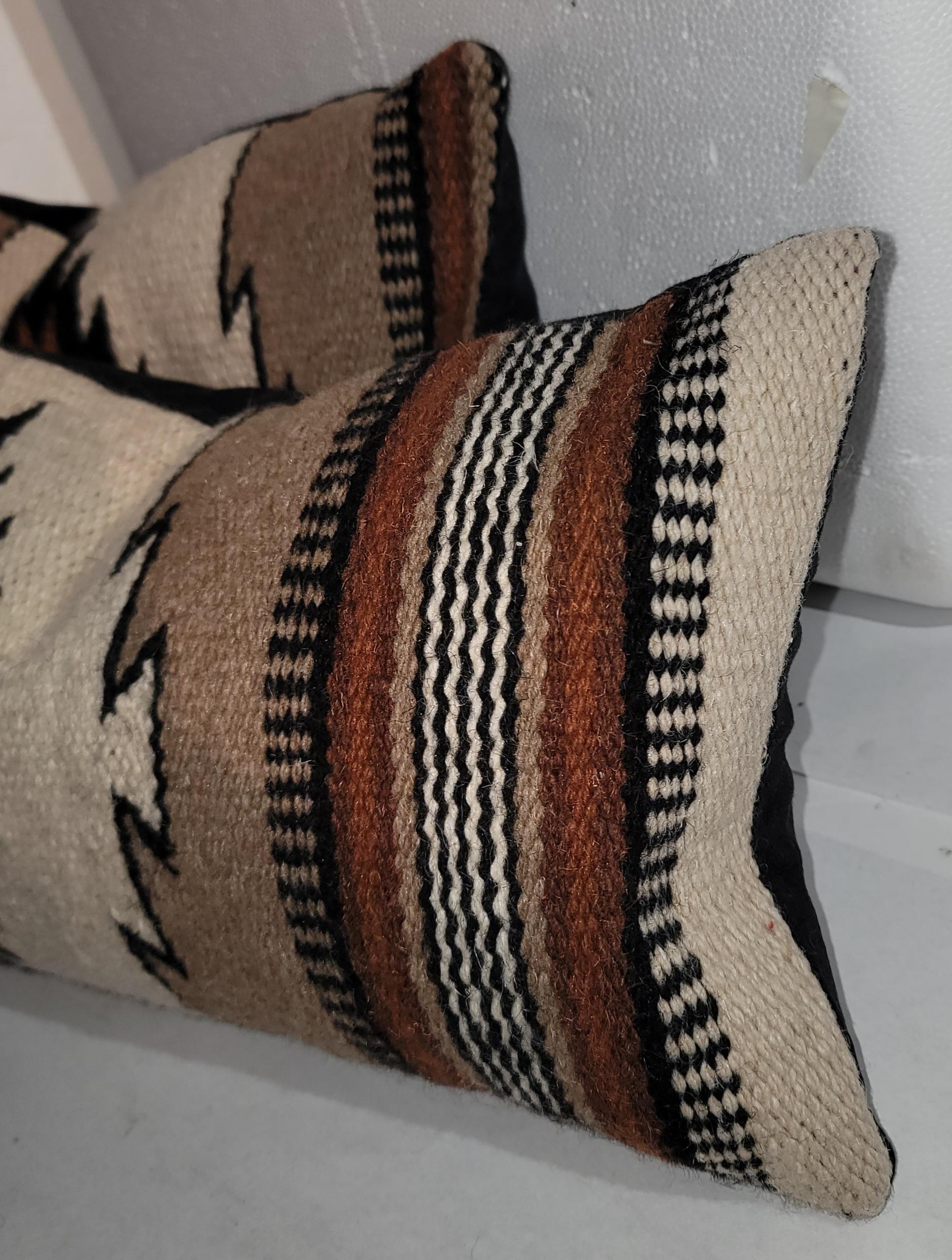 Mexican Indian weaving pillows are in fine condition and all have dark cotton linen backings. The inserts are down and feather fill.