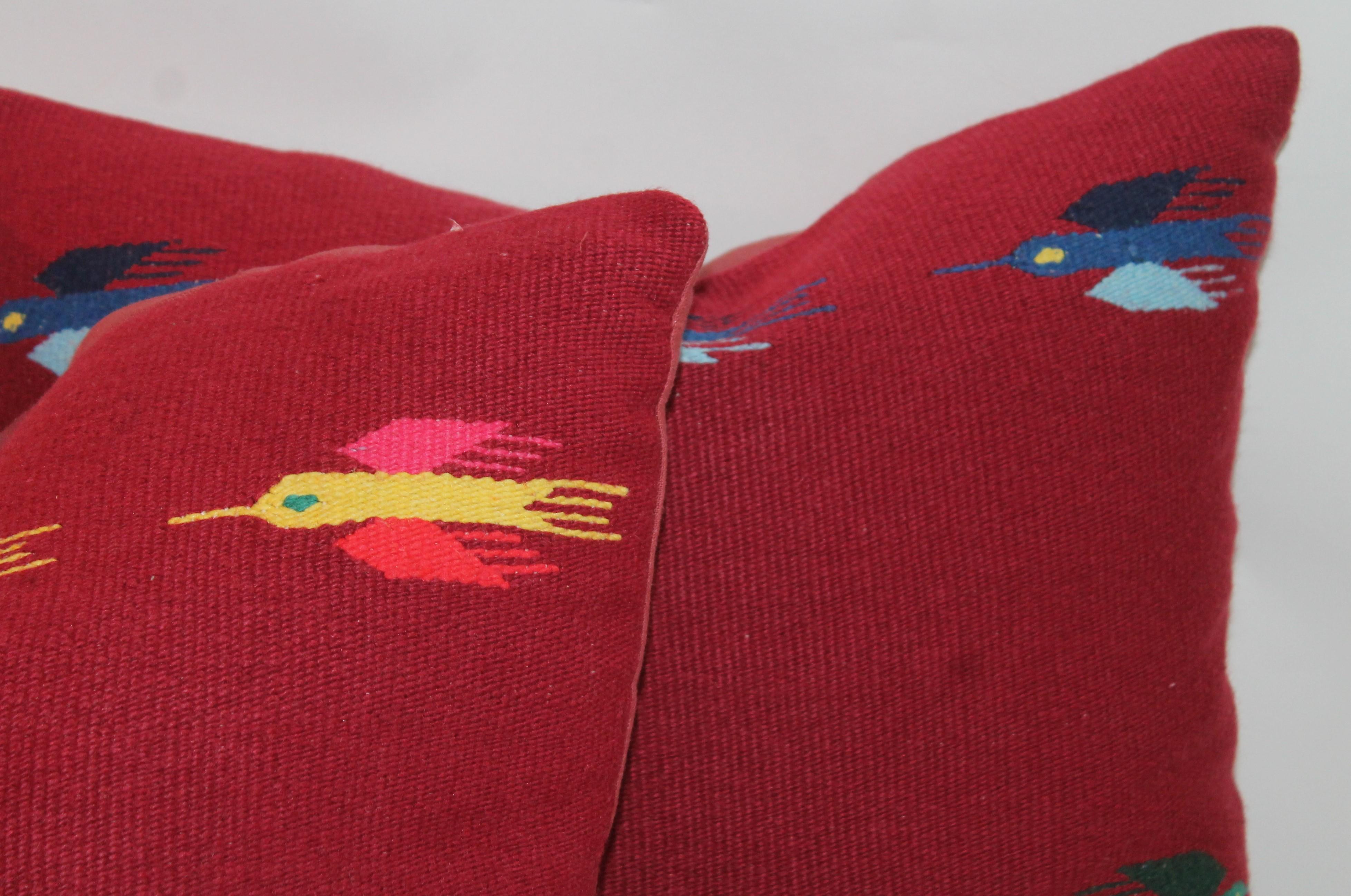 These cool Indian weaving pillows in the birds in flight pattern. The backing is in a cranberry cotton linen. All the colors in the Mexican serapes. Fantastic graphics. Two pairs in stock.