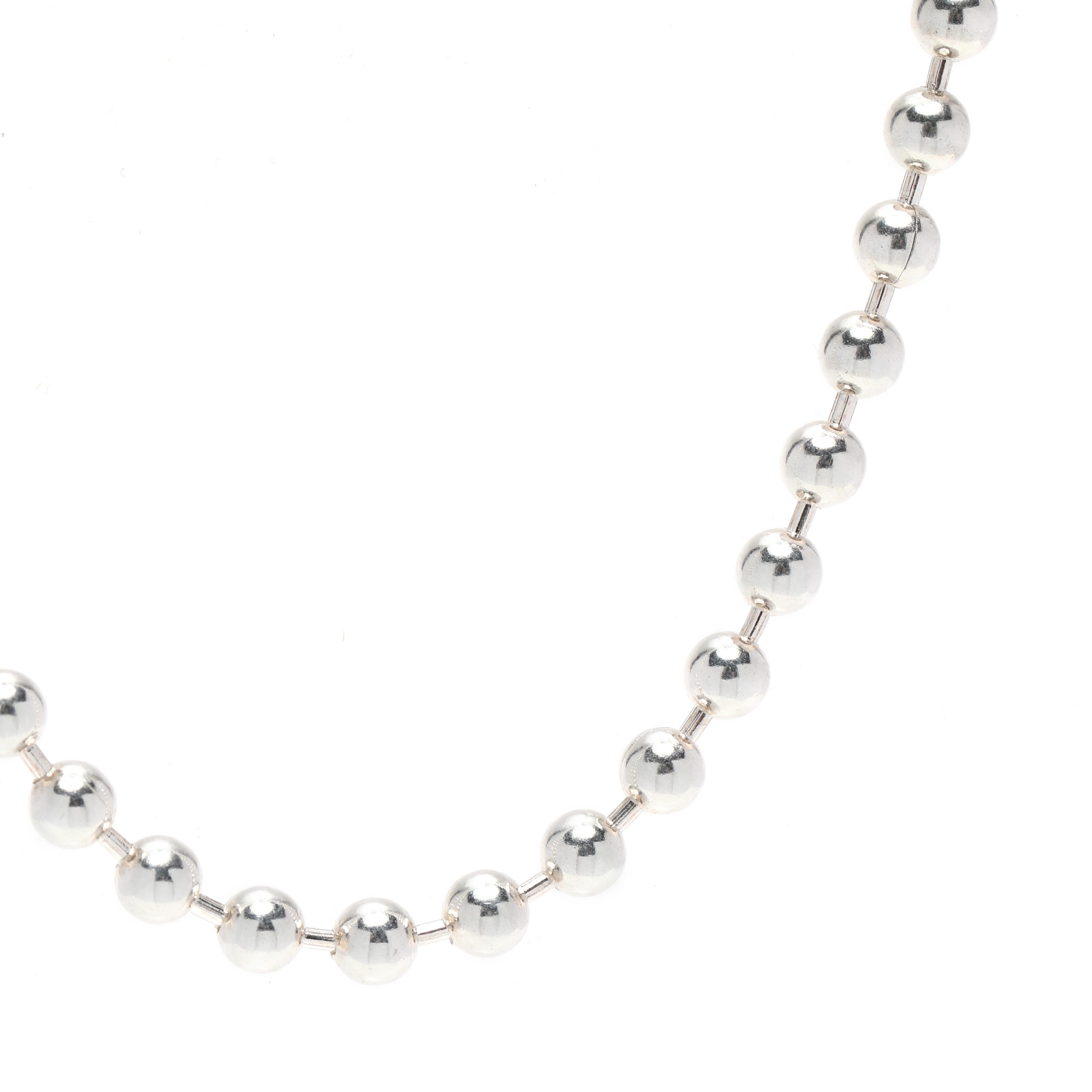 This Mexican medium bead chain necklace is the perfect statement piece for any outfit. Handcrafted from sterling silver, the necklace measures 21.5 inches in length and features a series of silver beaded chain links. The intricate design and