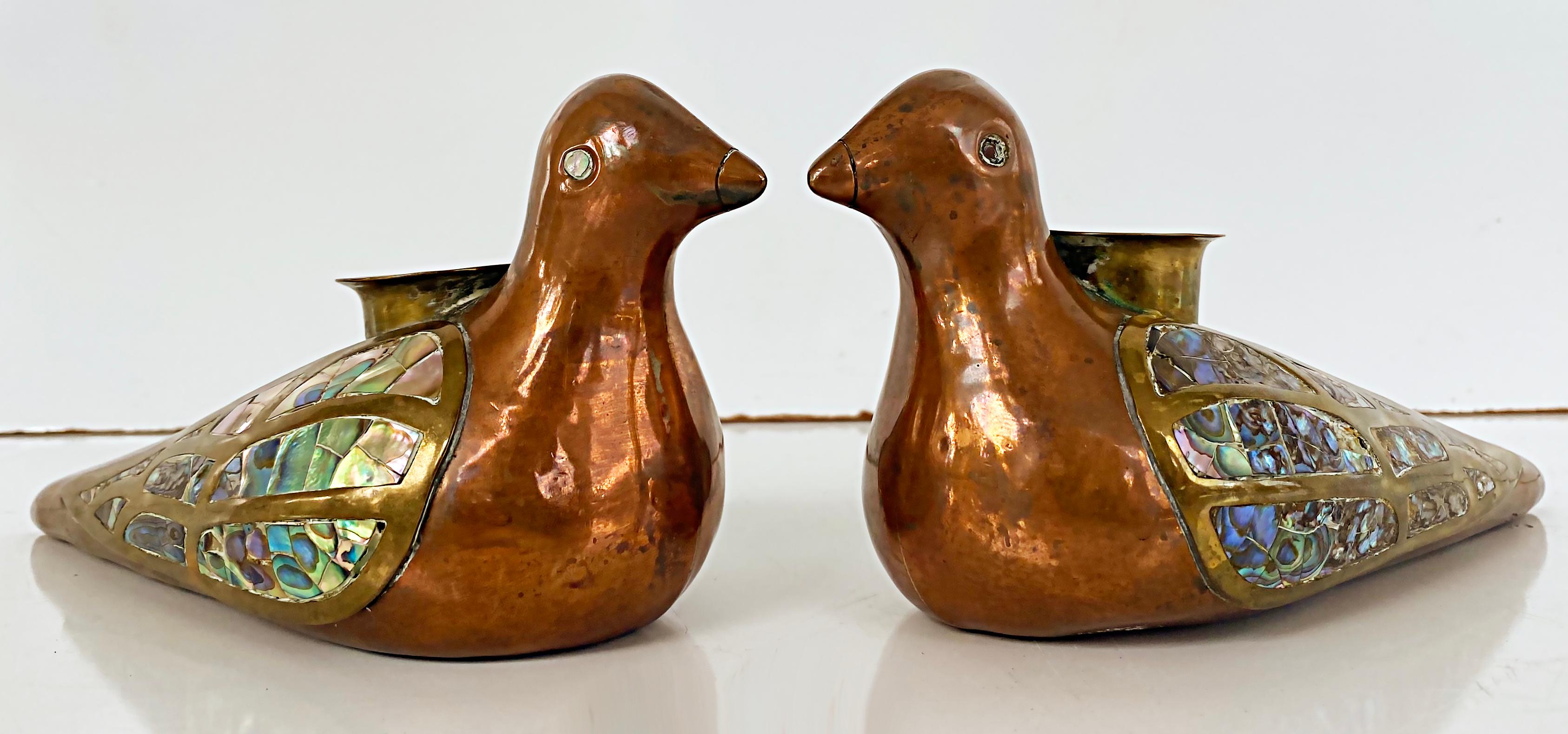 Mexican Mid-century Brass Copper Abalone Bird Candlesticks, Pair

Offered for sale is a pair of Mexican mid-century modern mixed metal brass, copper, and abalone shell figural candlesticks of birds c.1965. Although unmarked, these are reminiscent