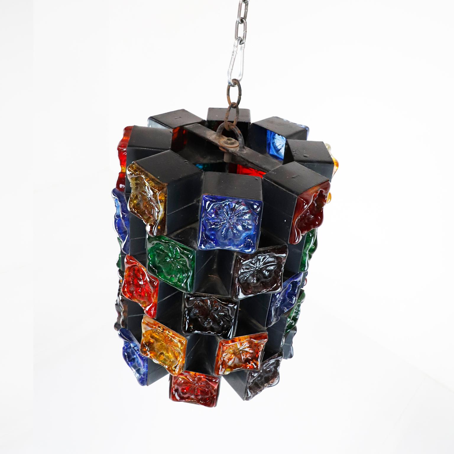 Circa 1970, we offer these original pendant light, these are one of the most stunning samples of Brutalist art designed by Felipe Delfinger. Made of iron and multicolored blown glass.