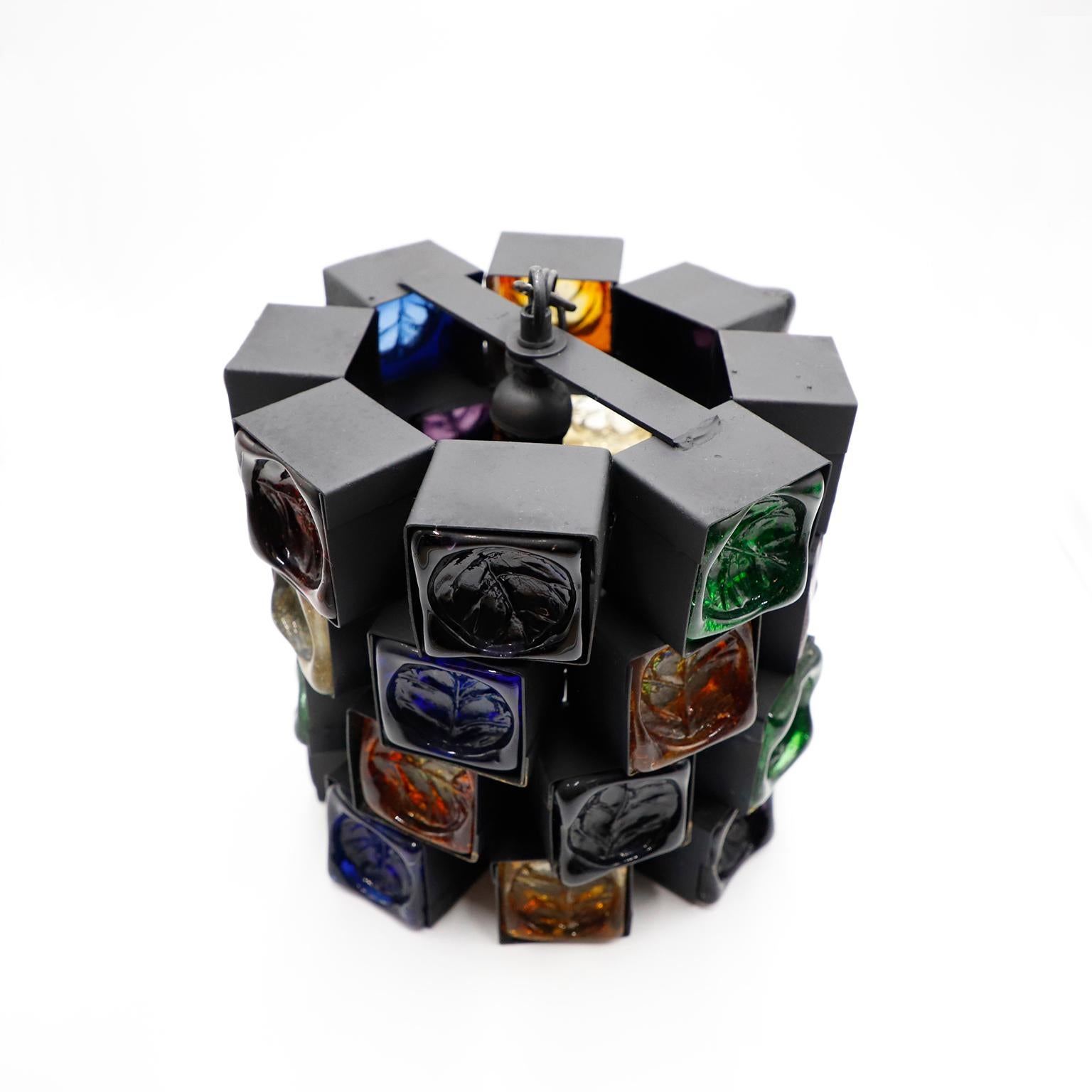 Circa 1970, we offer these original pendant light, these are one of the most stunning samples of Brutalist art designed by Felipe Delfinger. Made of iron and glass.