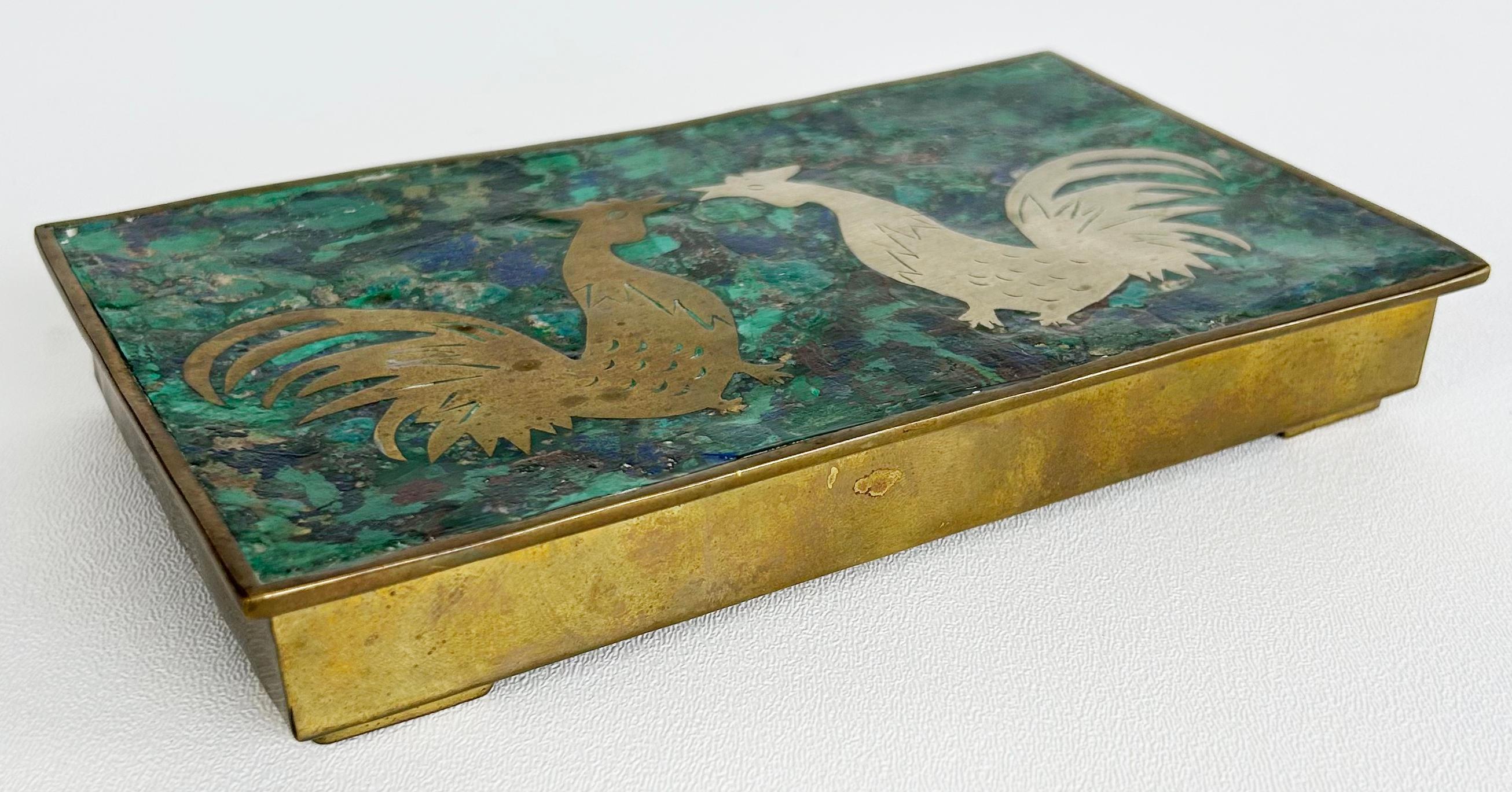 Mexican Mid-century Roosters Box, Salvador Teran Los Castillo Attributed

Offered for sale is a wonderful Mexican Mid-century Modern hand-made box created with 2 roosters fighting on the top. The top is inlaid with the mixed 
 metals brass and
