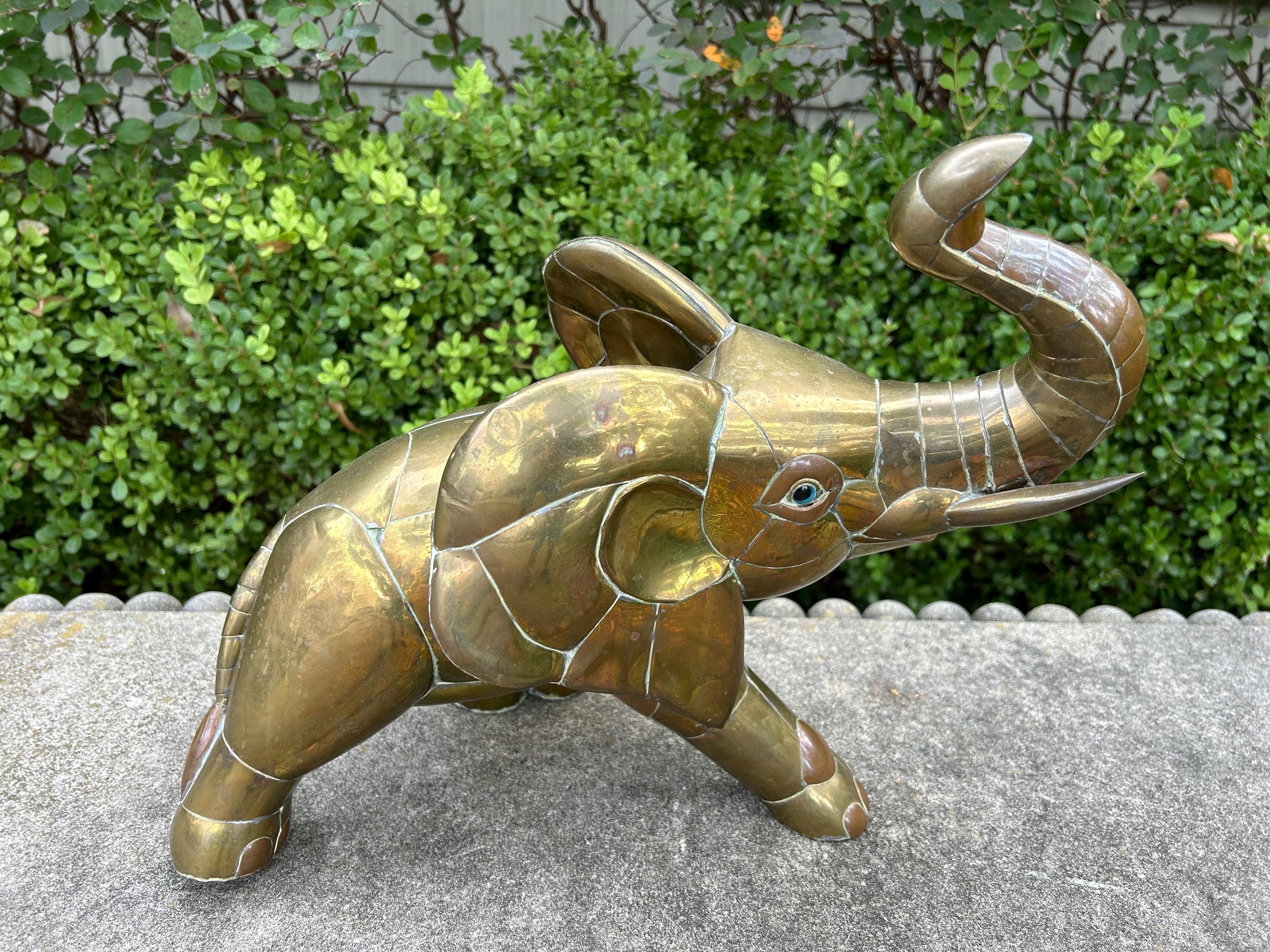 Mexican Modern Brass Sculpture Of An Elephant By Sergio Bustamante.
This stunning mid century Mexican sculpture was formed with cut pieces of brass fused together to create an interesting geometric elephant sculpture by the acclaimed sculptor Sergio