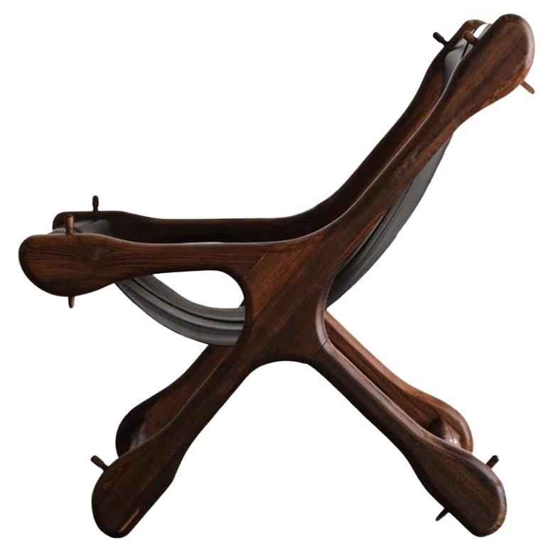 This is the Sloucher chair made in the 1960's. Leather has been restored. Made of Cocobolo Rosewood. 
Don S. Shoemaker (1919 - 1990) was born in Nebraska and studied at the Art Institute of Chicago. He first came to Mexico in the late 40's during