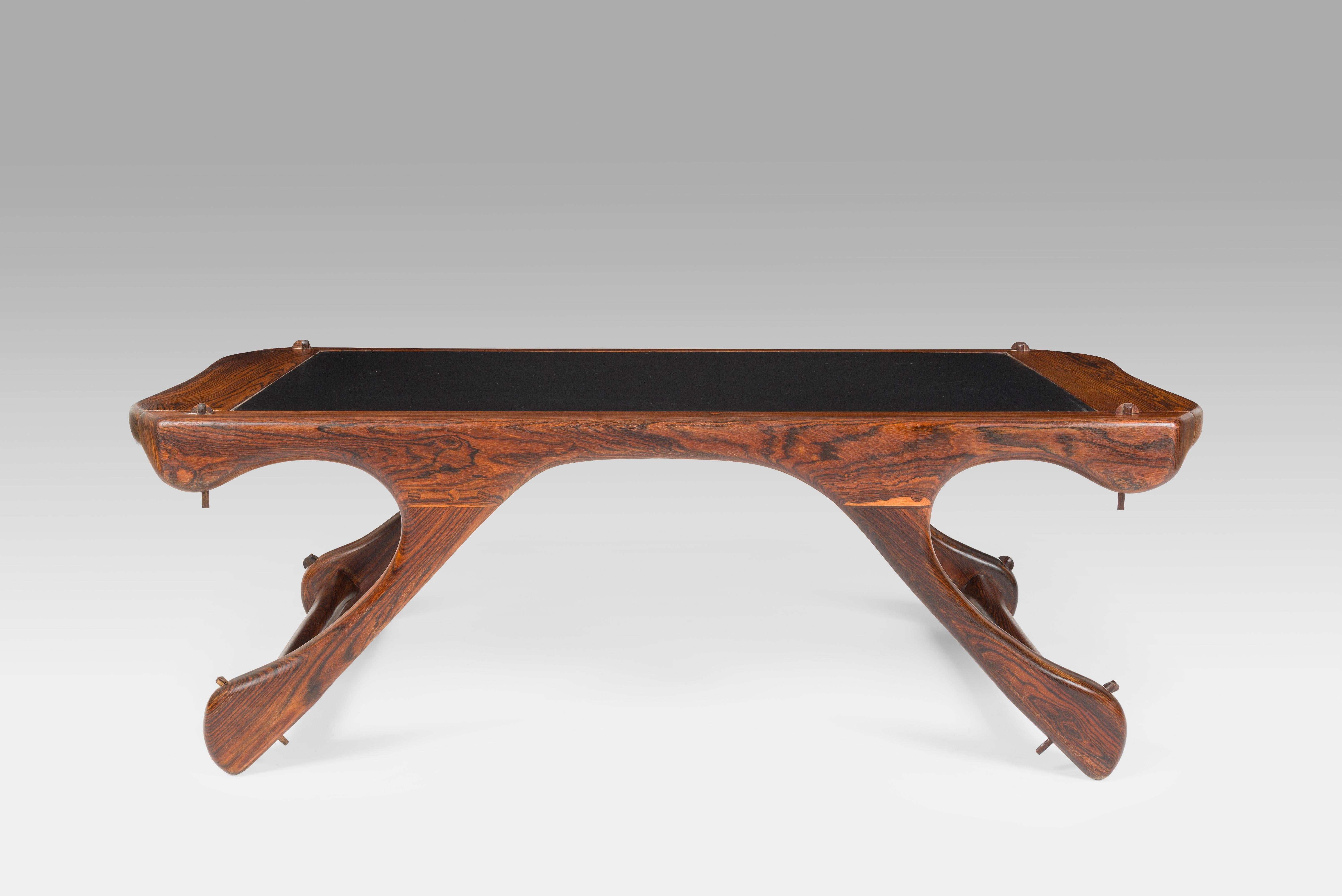 Label: Señal S.A.Hecho en Mexico.

Cocobolo wood and black leather mid-century modern coffee table from the sixties. The leather has a beautiful sensual feel and is in excellent condition. The cocobolo gives it a warm yet unique look with its