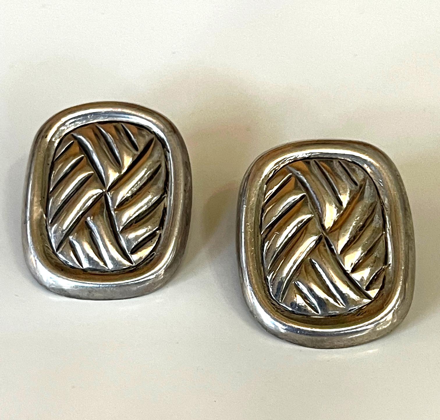 A pair of modernistic sterling silver earring by William Spratling from the third period 1964-1967. Made in his studio in Taxco, Mexico. The earring features an abstract woven motif within a border, inspired by indigenous basketry. Each stamped