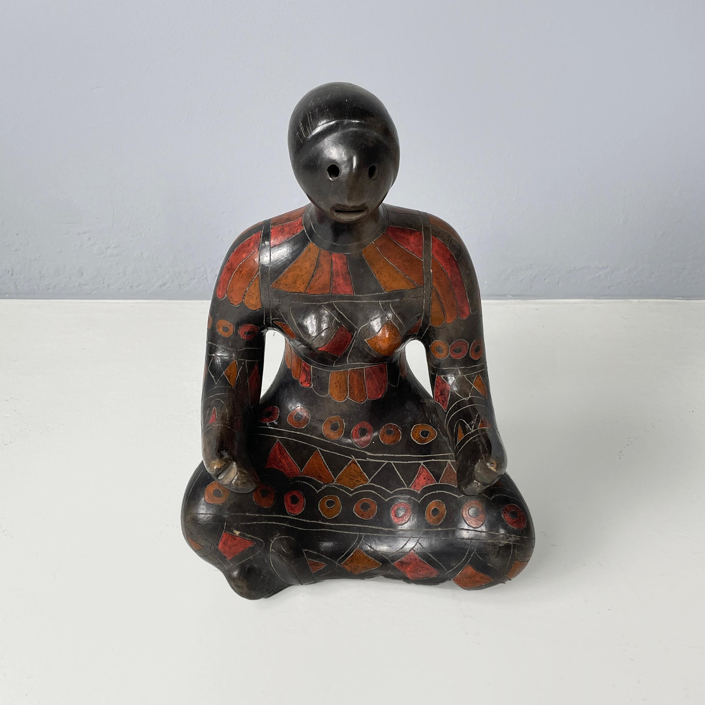 Mexican modern Terracotta sculpture of a woman by Manuel Felguerez, 1980s
Ethnic sculpture in terracotta painted in black and red. The subject is a woman with her hair tied in a braid and sitting cross-legged. Her dress is finished with geometric