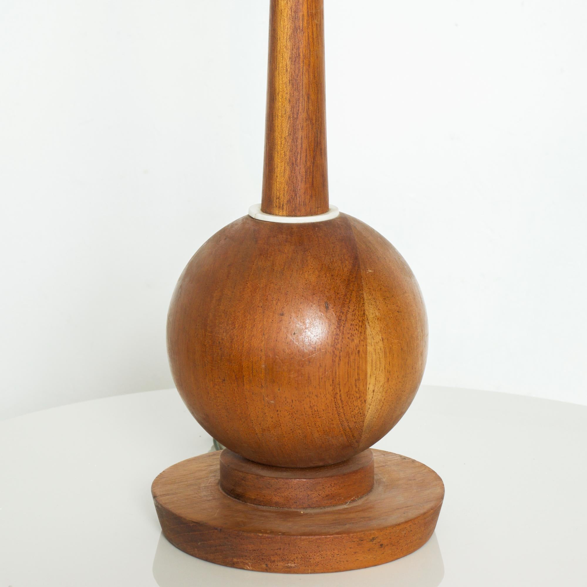 Midcentury Modernism in Mexican Mahogany Wood sculptural Globe Table Lamp with precise clean lines circa 1960s. Reminiscent of Tony Paul designs for Westwood.
Dimensions: 36