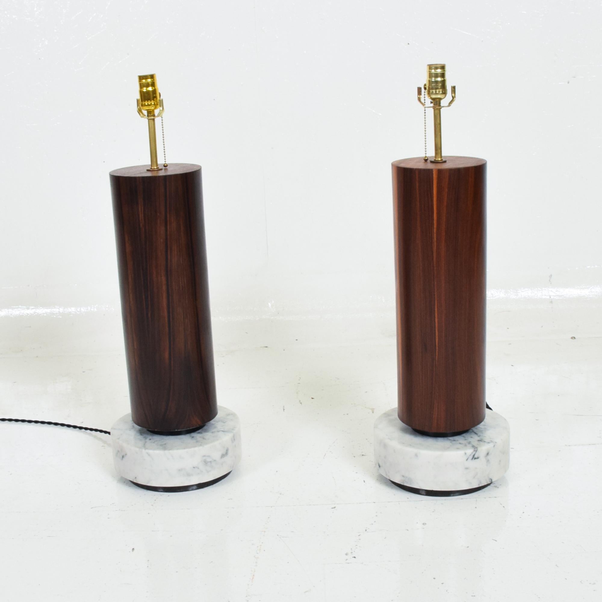 AMBIANIC presents
Modernist Tall Cylinder Table Lamps in Rosewood & Marble from Mexico City
Listing includes a pair.
In the style of designer Arturo Pani.
Made in Mexico 1960s. Unmarked.
30 H x 10 In diameter
Shades are not included.
Good vintage