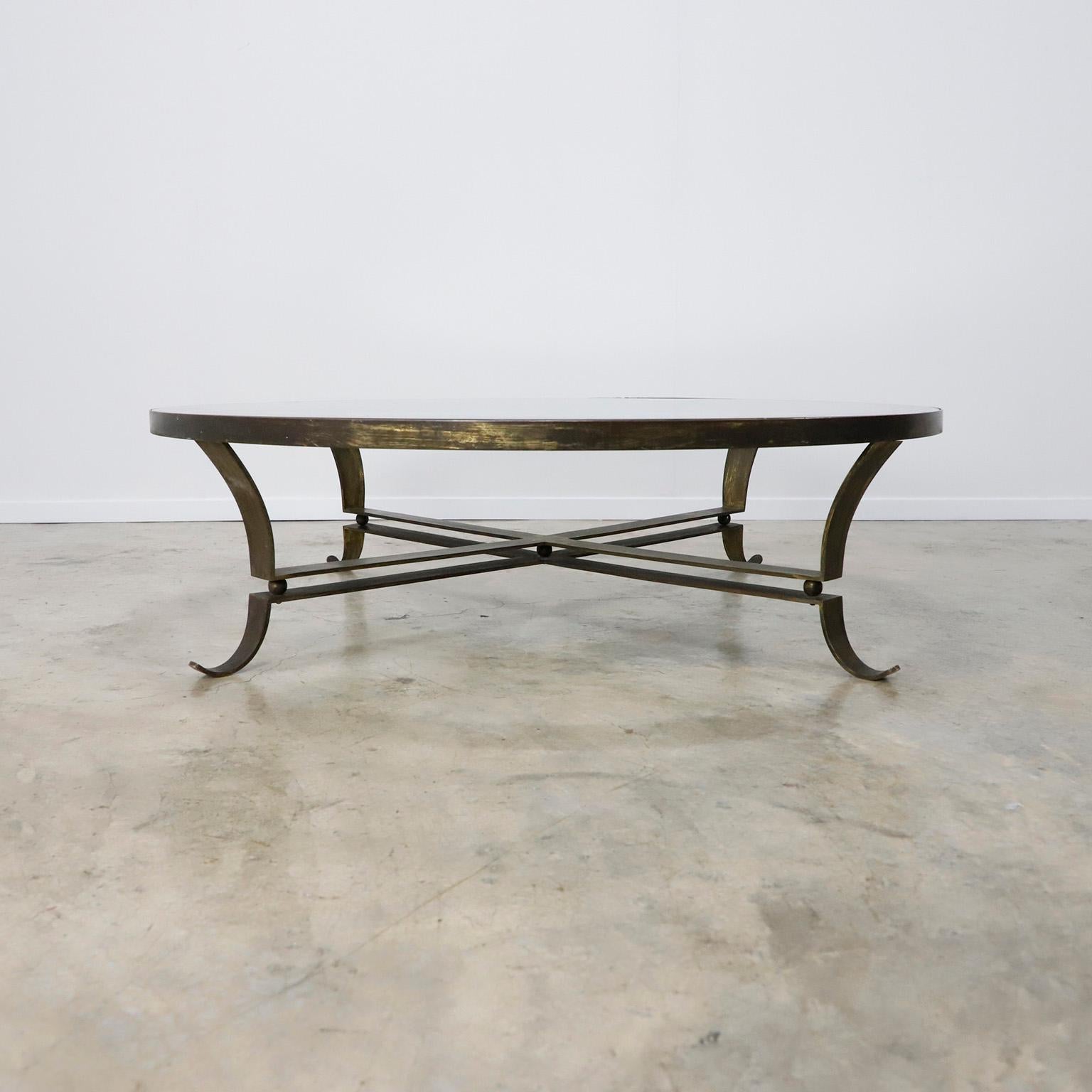Made in Mexico, circa 1950s, designed by Arturo Pani, the table has original mirror glass and solid brass base.