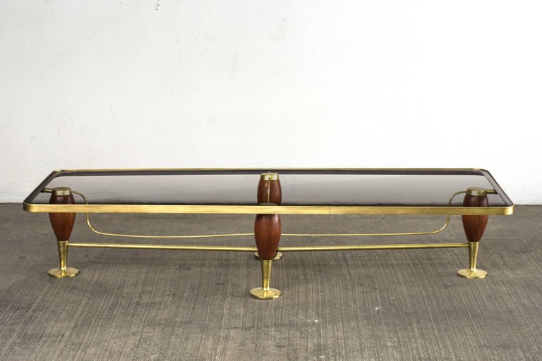 Arturo Pani brass and mahogany cocktail table circa 1950. Arturo Pani was the decorator du jour for Mexico’s elite from the mid-1930s through the mid-1970s. After studying interior design and decoration at the Ecole des Beaux Arts in Paris in the