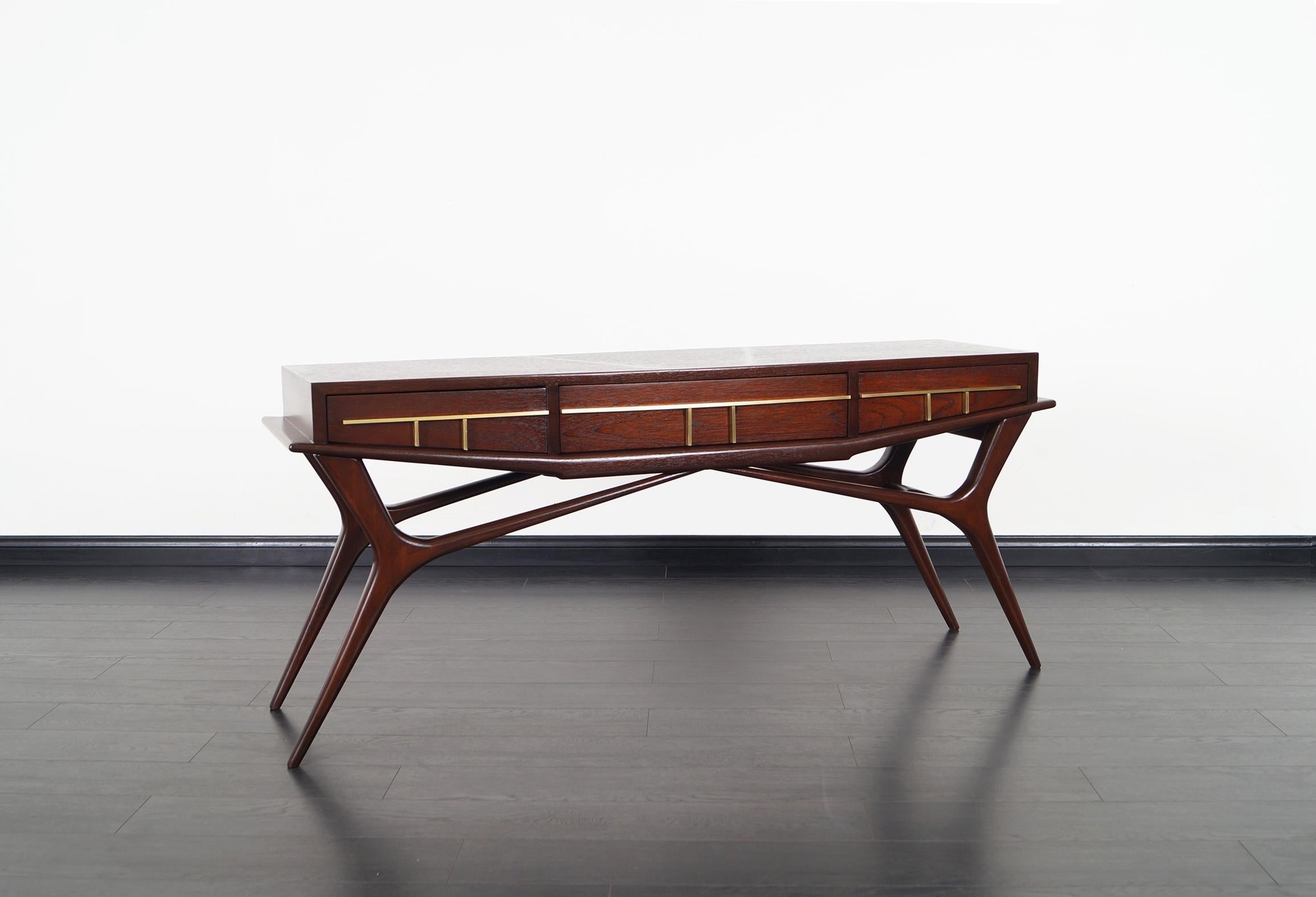 Stunning Mexican modernist console table designed by Frank Kyle. This phenomenal console table is simply amazing! Features three pull-out drawers with solid brass hardware.