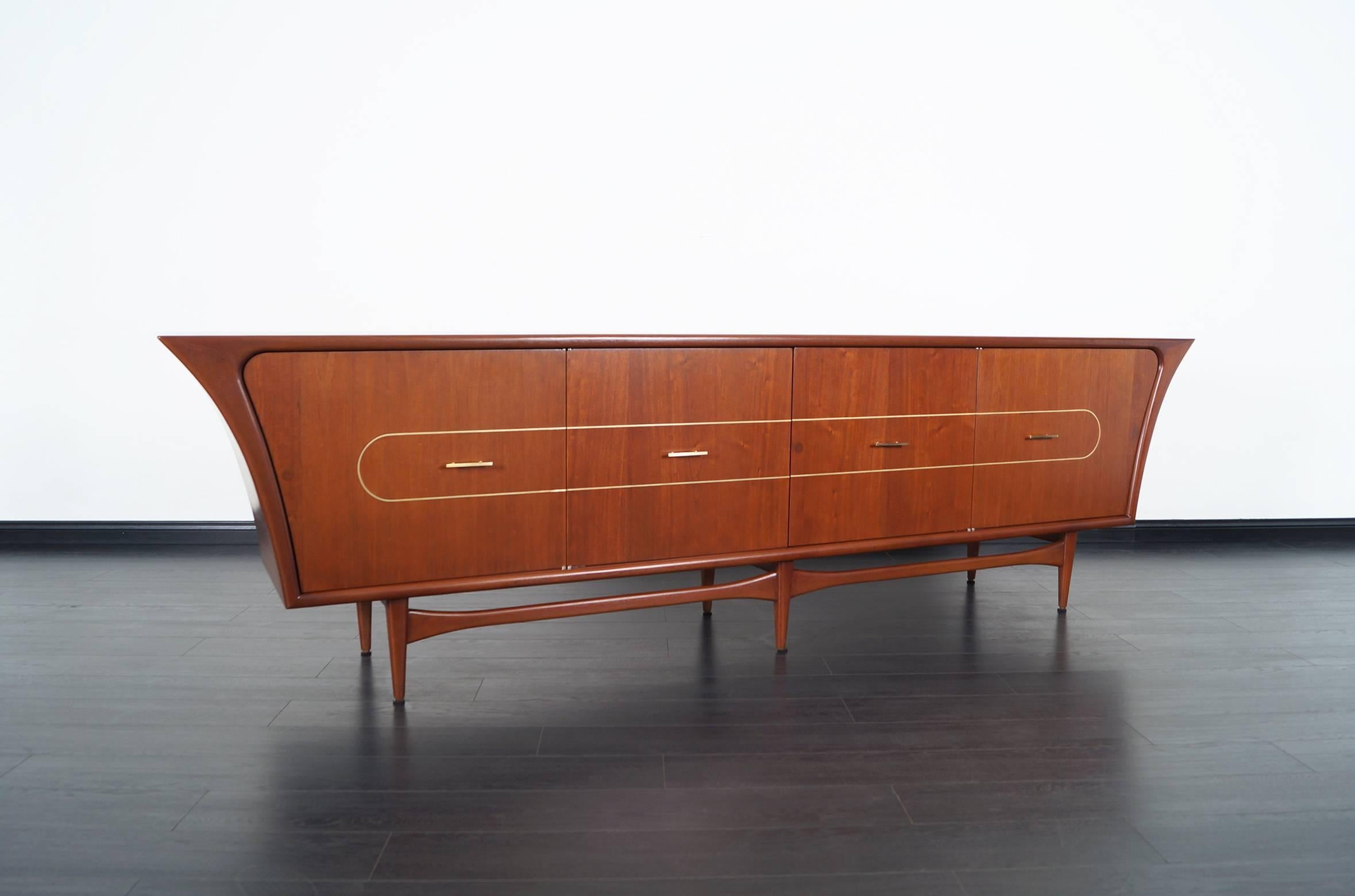 Monumental Mexican modernist credenza designed by Eugenio Escudero. This spectacular credenza is simply amazing! Features three shelves, three drawers, and sold brass hardware.