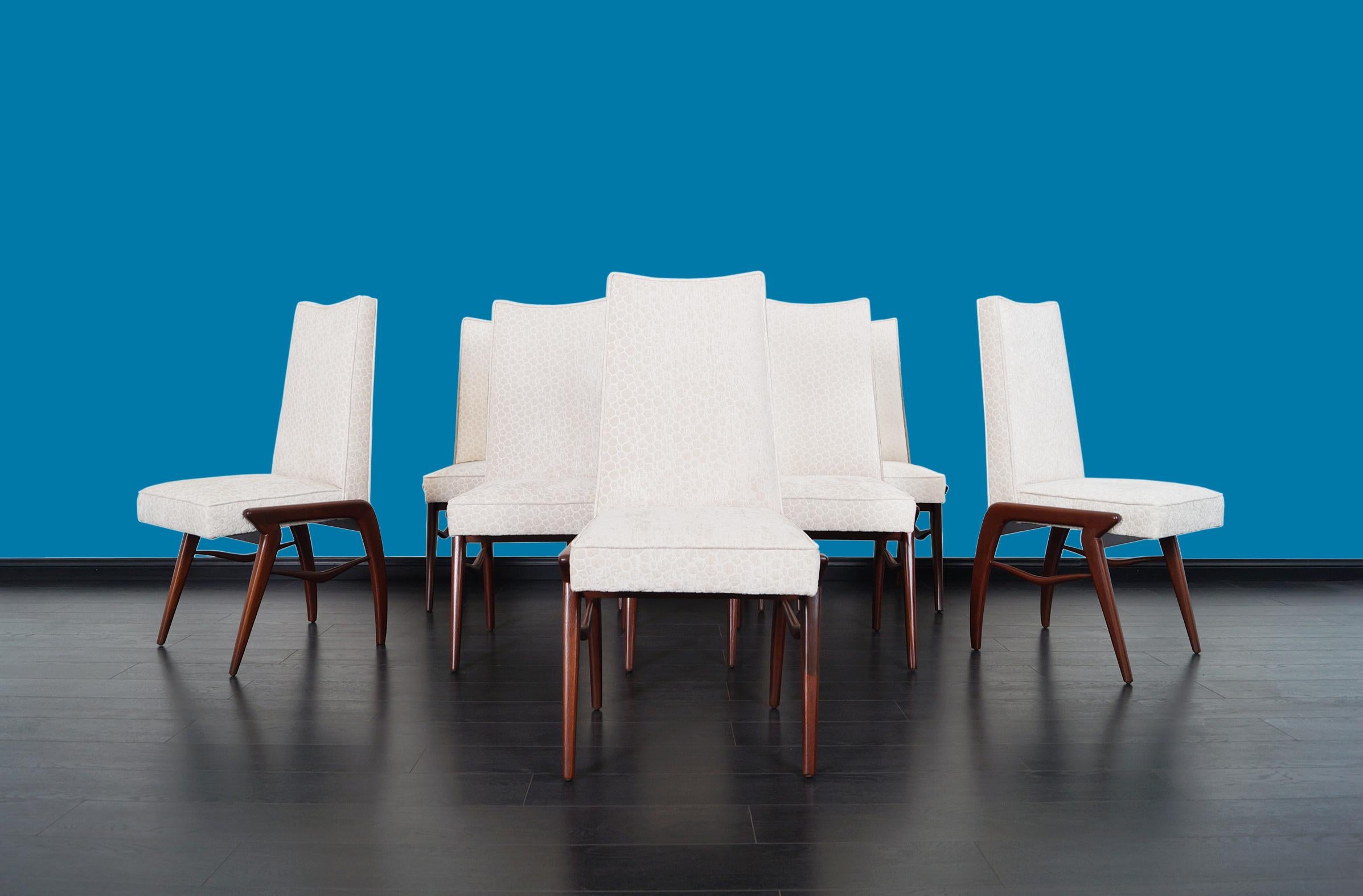 Stunning set of eight vintage Mexican modernist dining chairs designed by Eugenio Escudero. These chairs have a clean and innovative design, they have an elegant solid walnut base in which the symmetrically placed “V” shaped joints stand out. The