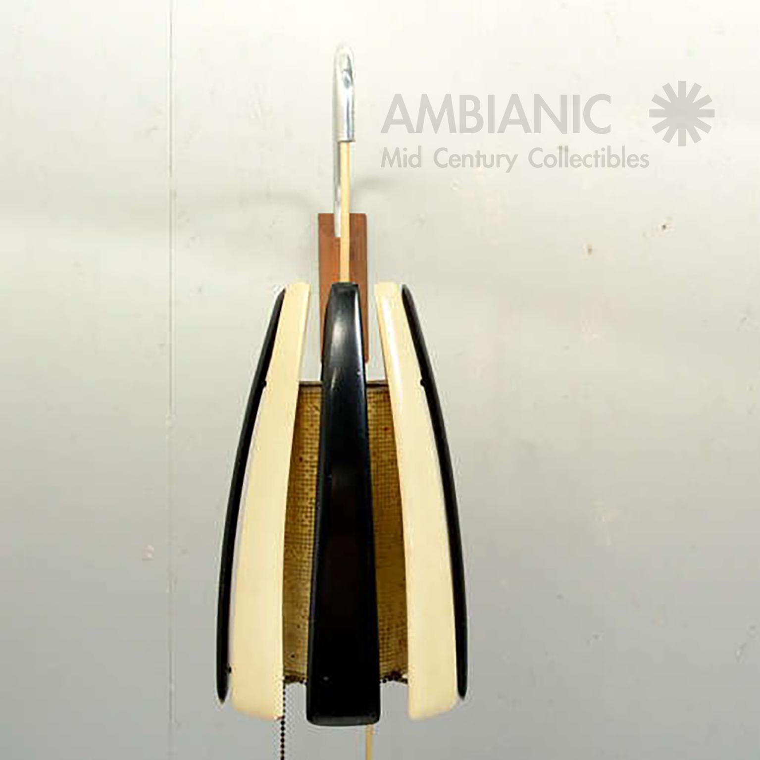 We are proud to offer: Mexican modern wall sconce in mahogany, Mexico, circa 1960s. Styled after Eugenio Escudero.

Sculptural mahogany strips painted in ivory and black. Features a custom plexiglass shade. 

Dimensions: 20