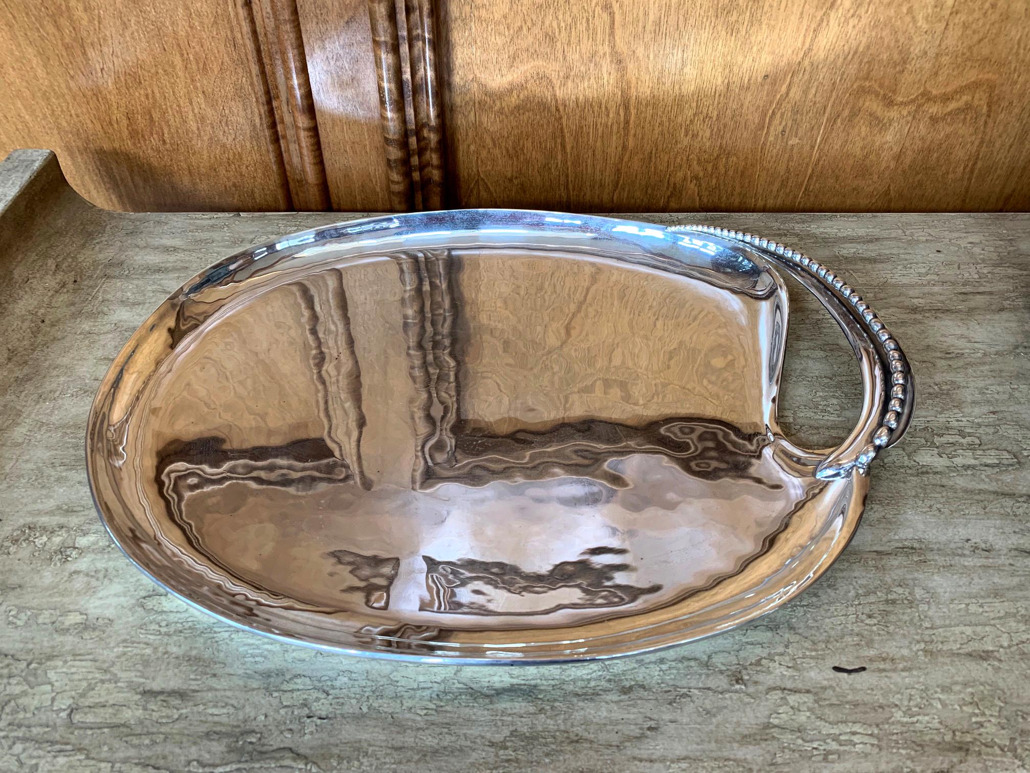 A Mexican modernist sterling silver tray by well known silversmith Antonio Pineda (1919-2009). The handsome silver tray with a subtle hammered surface was crown marked by the artist's logo circa 1953-1979, made in his studio in Taxco, Mexico. It was