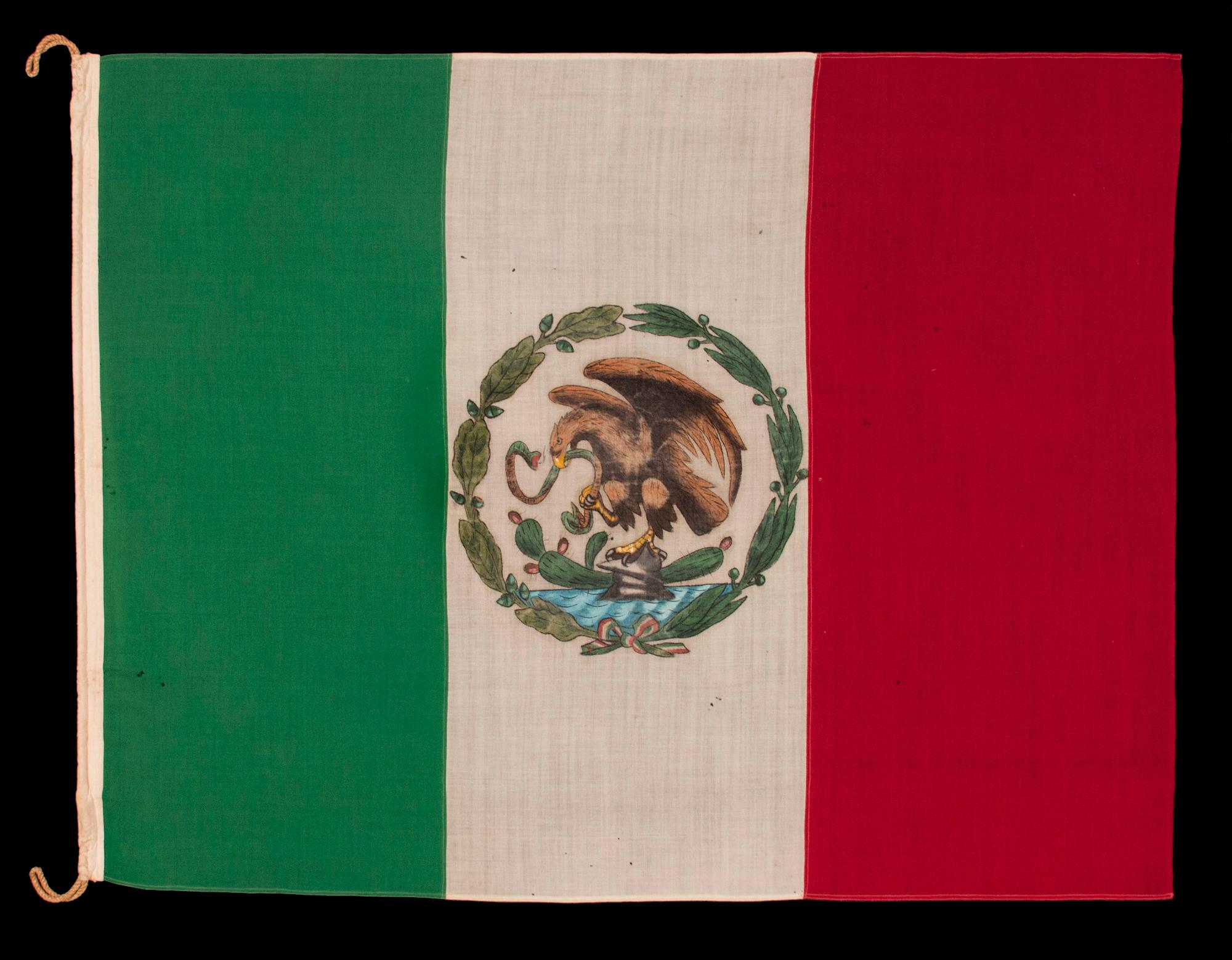 MEXICAN NATIONAL FLAG IN THE DESIGN USED BY REVOLUTIONARIES FROM 1917 - 1934, THE FIRST PERIOD IN WHICH THE EAGLE WAS ILLUSTRATED IN SIDE VIEW; MADE OF GABARDINE WOOL AND WOOL BUNTING, WITH RICH COLORS AND A HAND-PAINTED DEVICE, USED IN THE LATTER