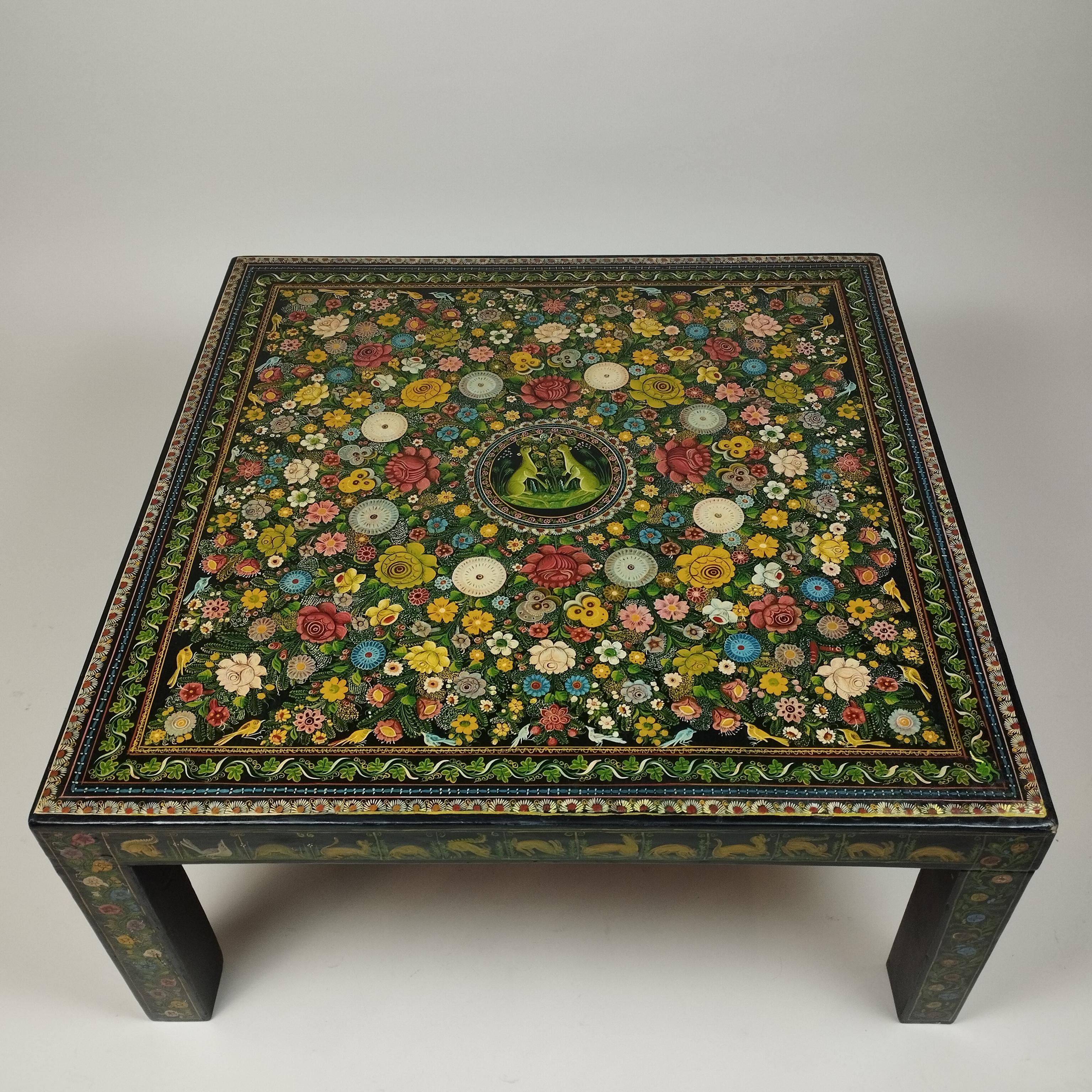 A ca. 1950s Mexican folk art coffee table from Olinalá, Guerrero. The wood structure is covered by hand-painted lacquer decoration depicting flowers and animals on a black background. 

Olinalá, Guerrero is a city in south-west Mexico known by