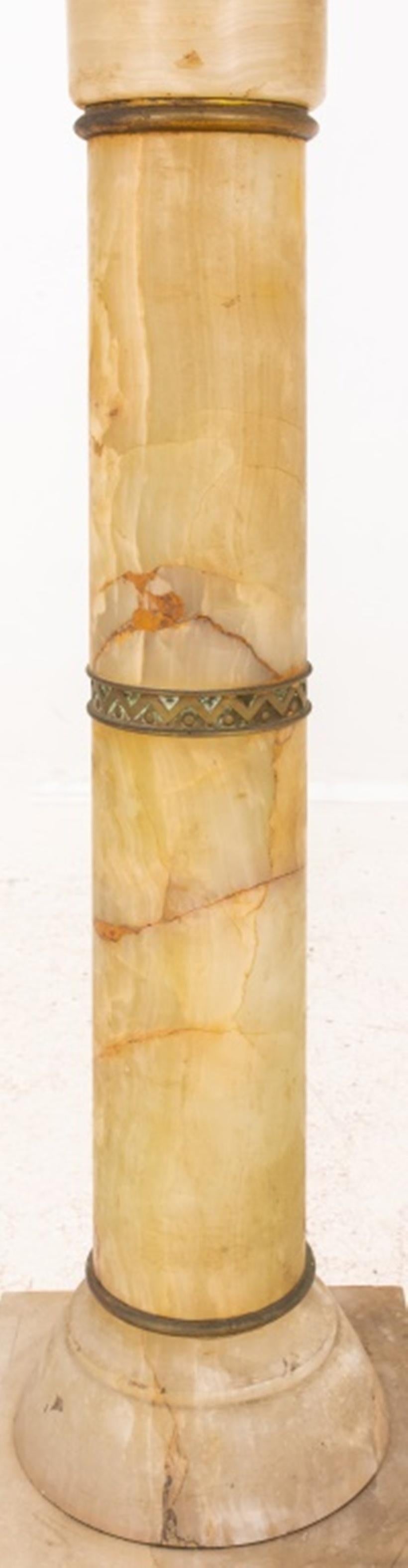 Mexican onyx pedestal, circular and in four sections with gilt bronze spacers above a square base, circa 1900-1920. 

Dealer: S138XX.