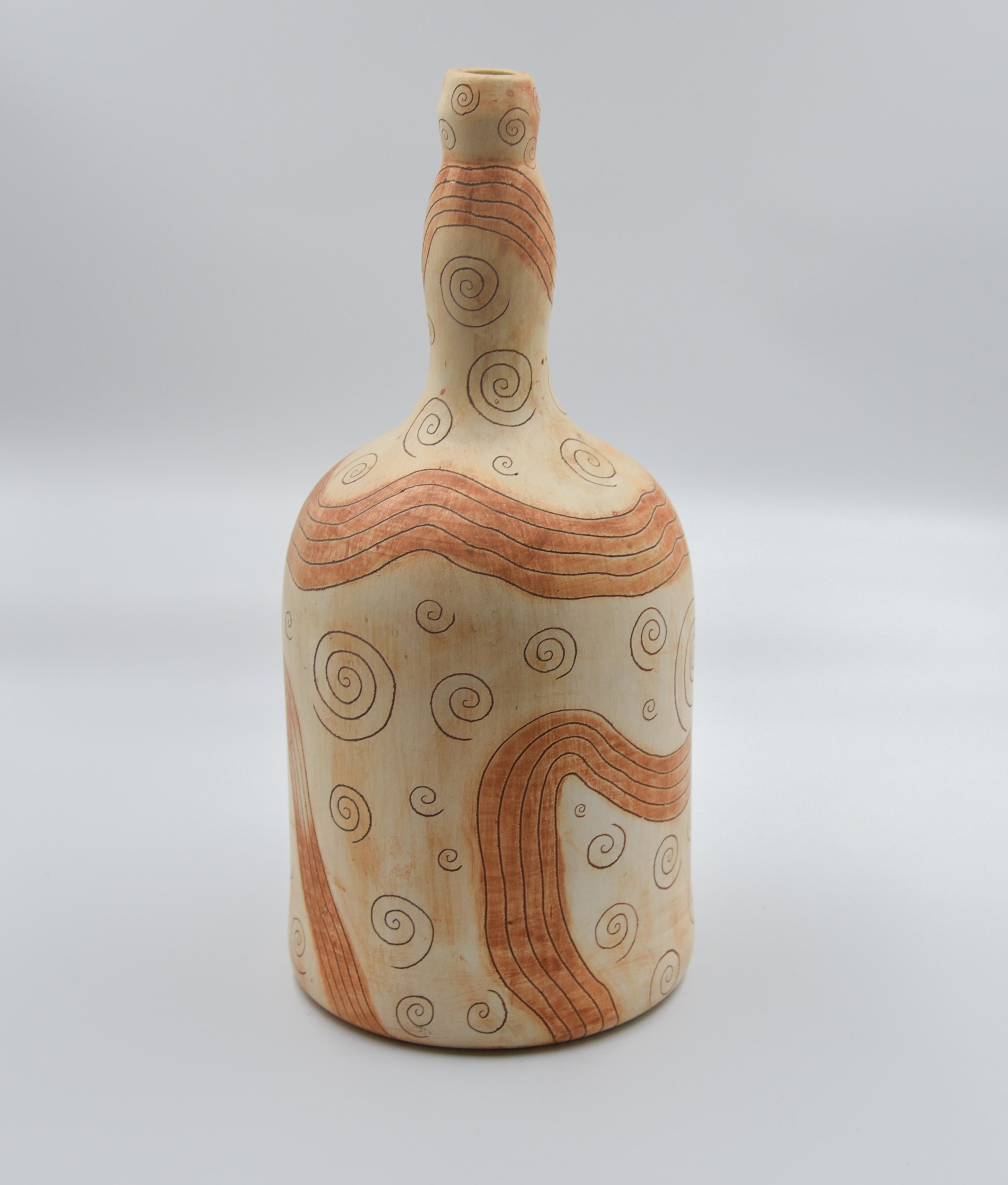 This rustic mezcal bottle is a replica of an antique bottle which was used to store mezcal, drunken during folk theaters in Oaxaca, Mexico. The bottle is done with ceramic graffiti sgraffito technique which is later painted with oxide and earth. In