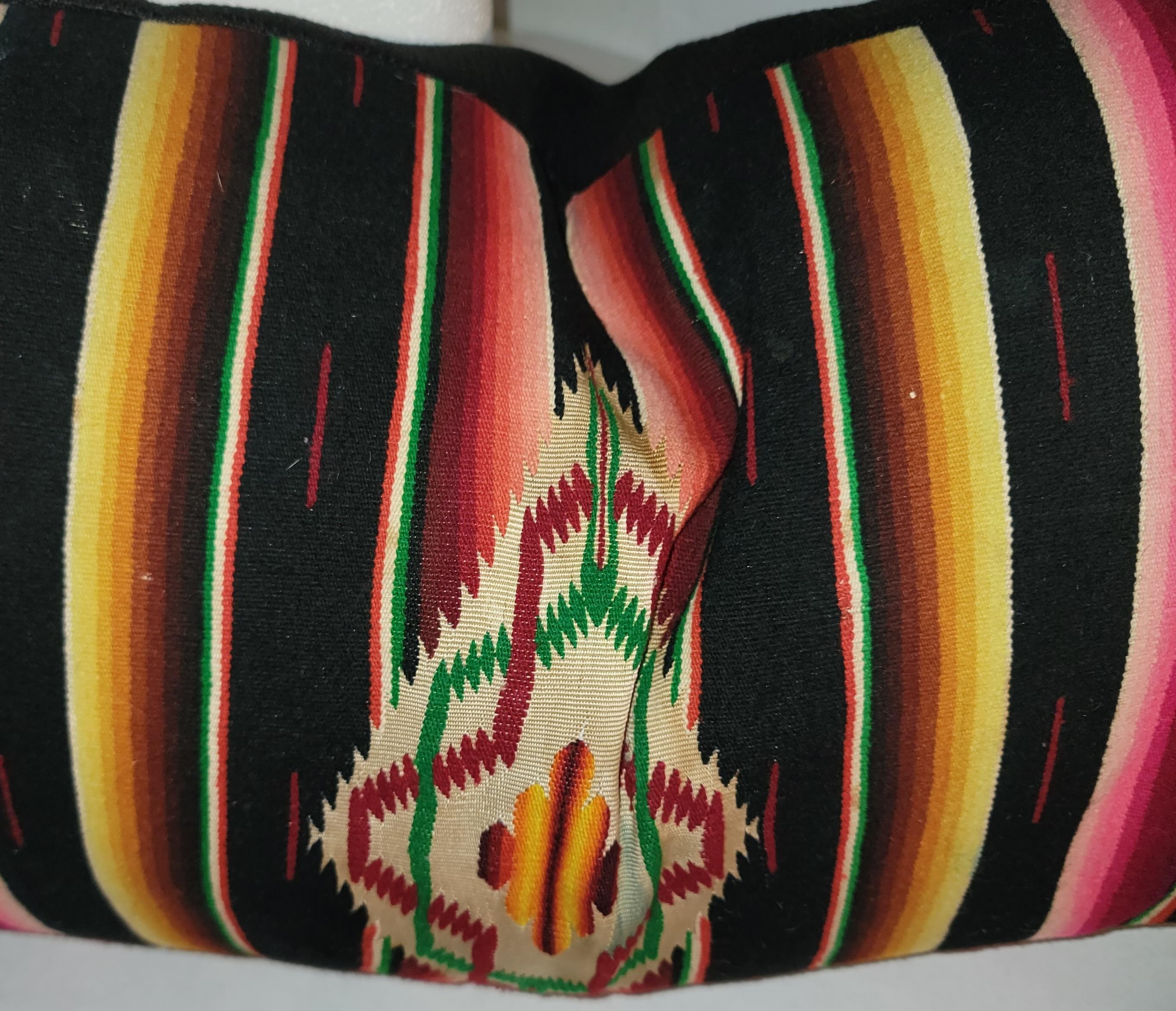 Early 20Thc Hand woven black back round Mexican serape bolster pillow. Its very rare to find the black back round.The insert is down & feather fill.