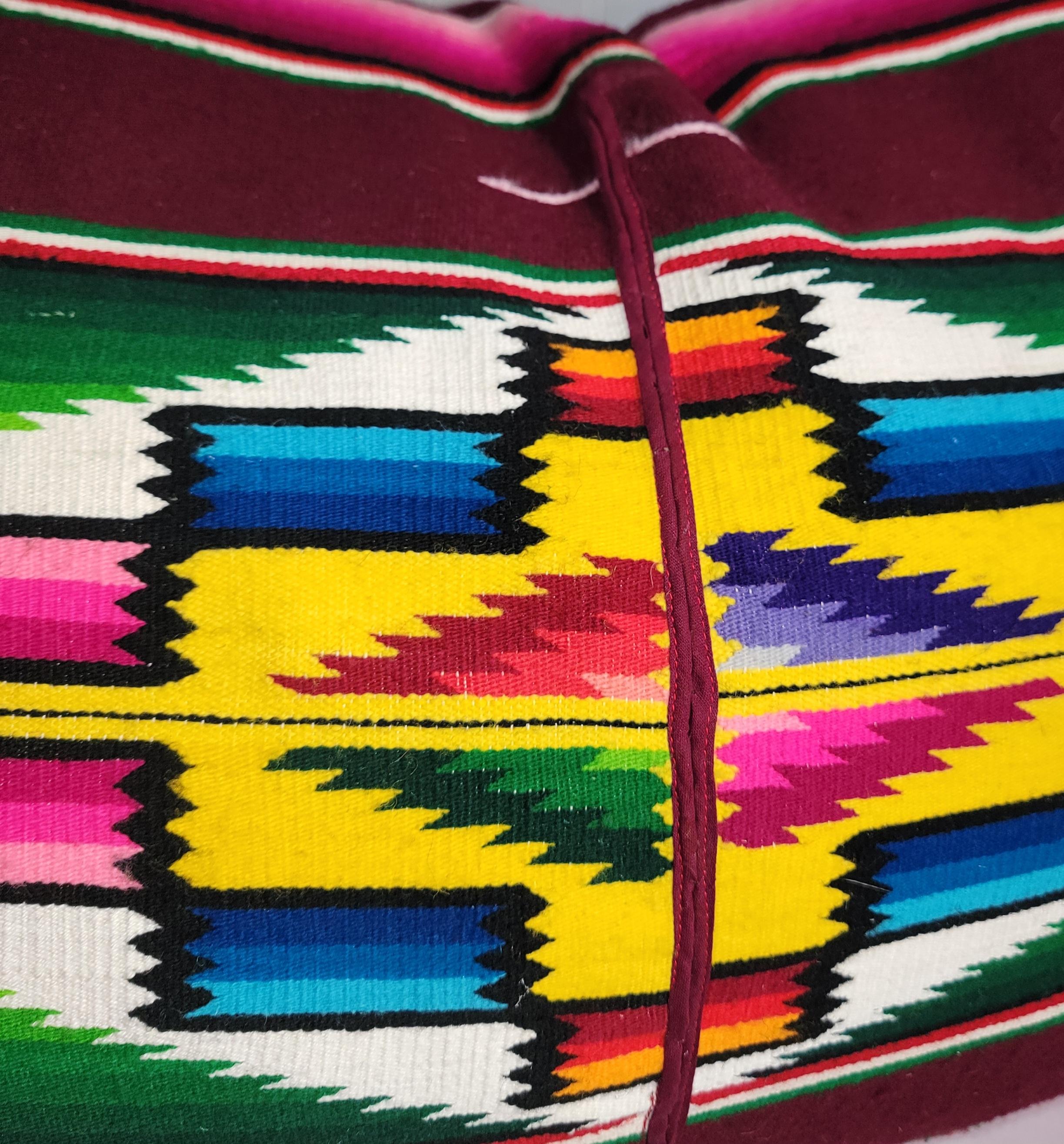 Mexican serape pillow with the center eye design.The backing is a deep maroon velvet and the in sert is down & feather fill.