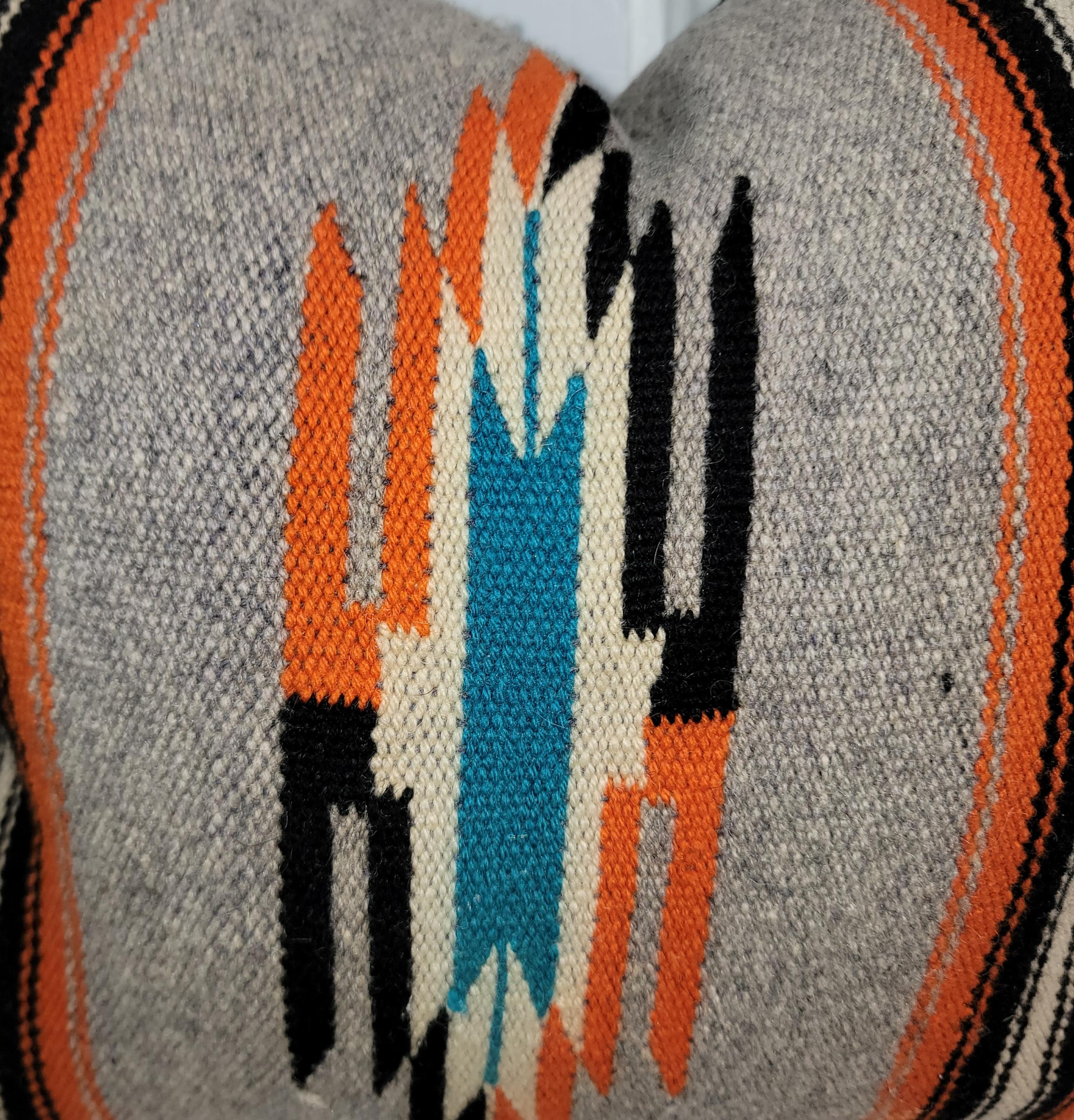 Wonderful wool serape pillow in a wonderful color pallet. Oranges and blues highlight this pillow and are a great mix to the deep colors surrounding the bright colors. has been fitted with a down and feather custom insert.